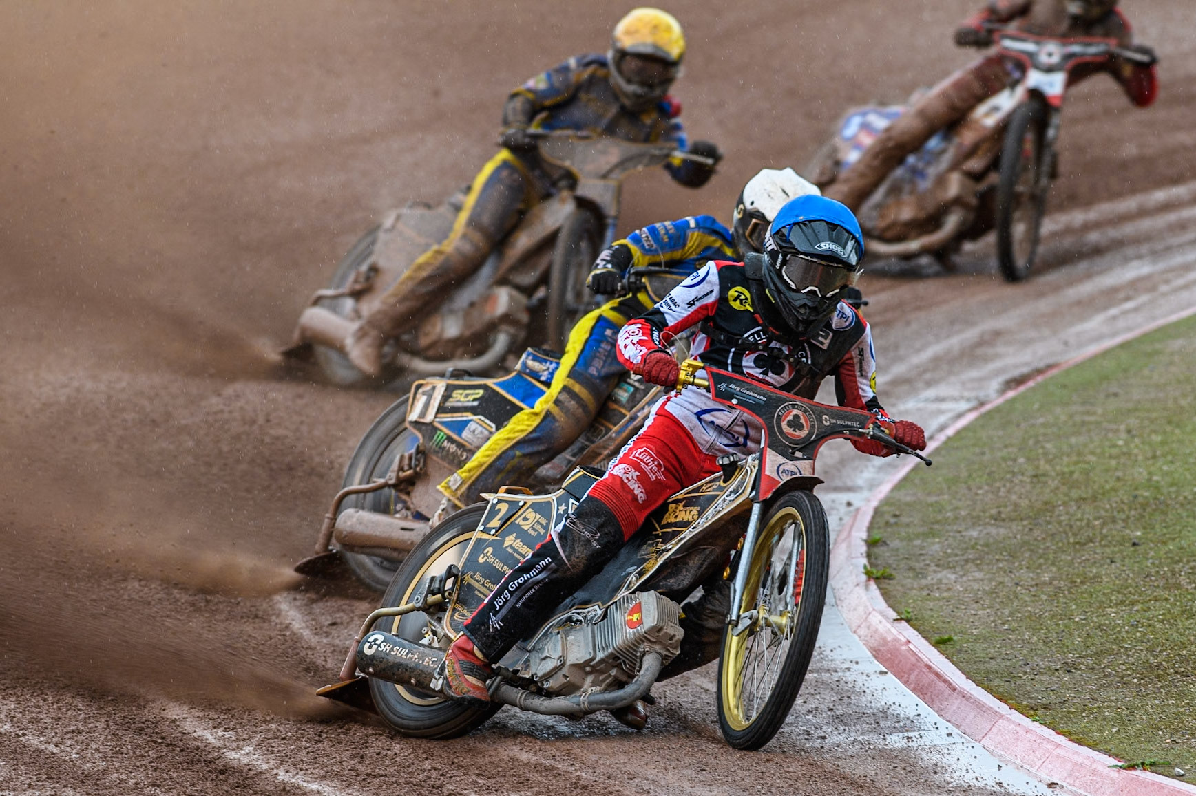 Belle Vue Aces' Norick Blodorn in Blue leading Sheffield Tigers' Jack Holder in White and Sheffield Tigers' Kyle Howarth in Yellow during the Rowe Motor Oil Premiership match between Belle Vue Aces and Sheffield Tigers at the National Speedway Stadium, Manchester on Monday 27th May 2024. (Photo: Ian Charles | MI News)