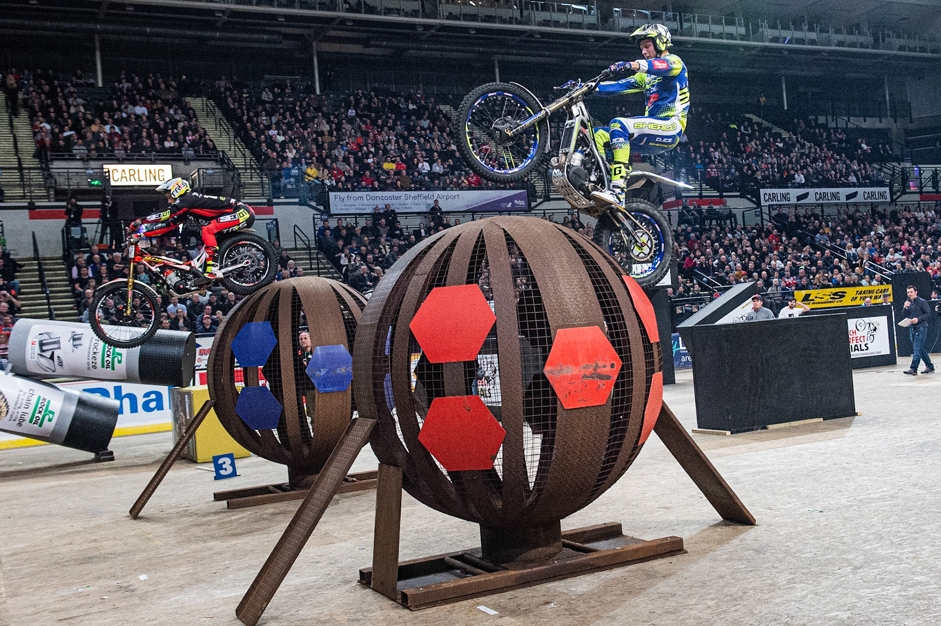 SHEFFIELD, ENGLAND  - DECEMBER 28TH  Dan Peace, UK (Sherco) (right) goes over the globes against Toby Martyn, UK (Beta)  during the 25th Anniversary Sheffield Indoor Trial at the FlyDSA Arena, Sheffield on Saturday 28th December 2019. (Credit: Ian Charles | MI News)
