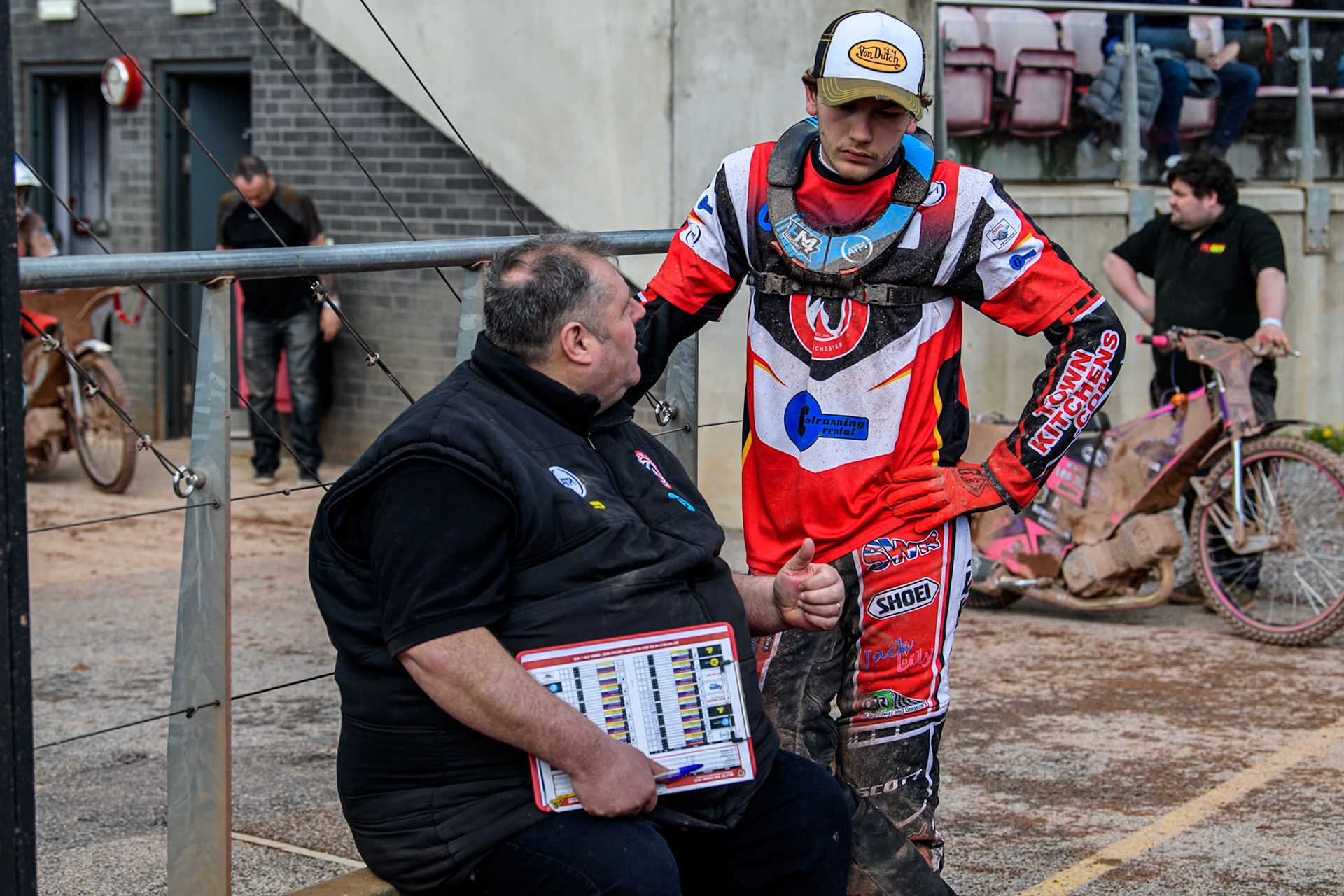 Belle Vue Colts' Joint Team Manager Steve Williams (Left) chats with Belle Vue Colts' Harry McGurk during the WSRA National Development League match between Belle Vue Colts and Leicester Lion Cubs at the National Speedway Stadium, Manchester on Friday 29th March 2024. (Photo: Ian Charles | MI News)