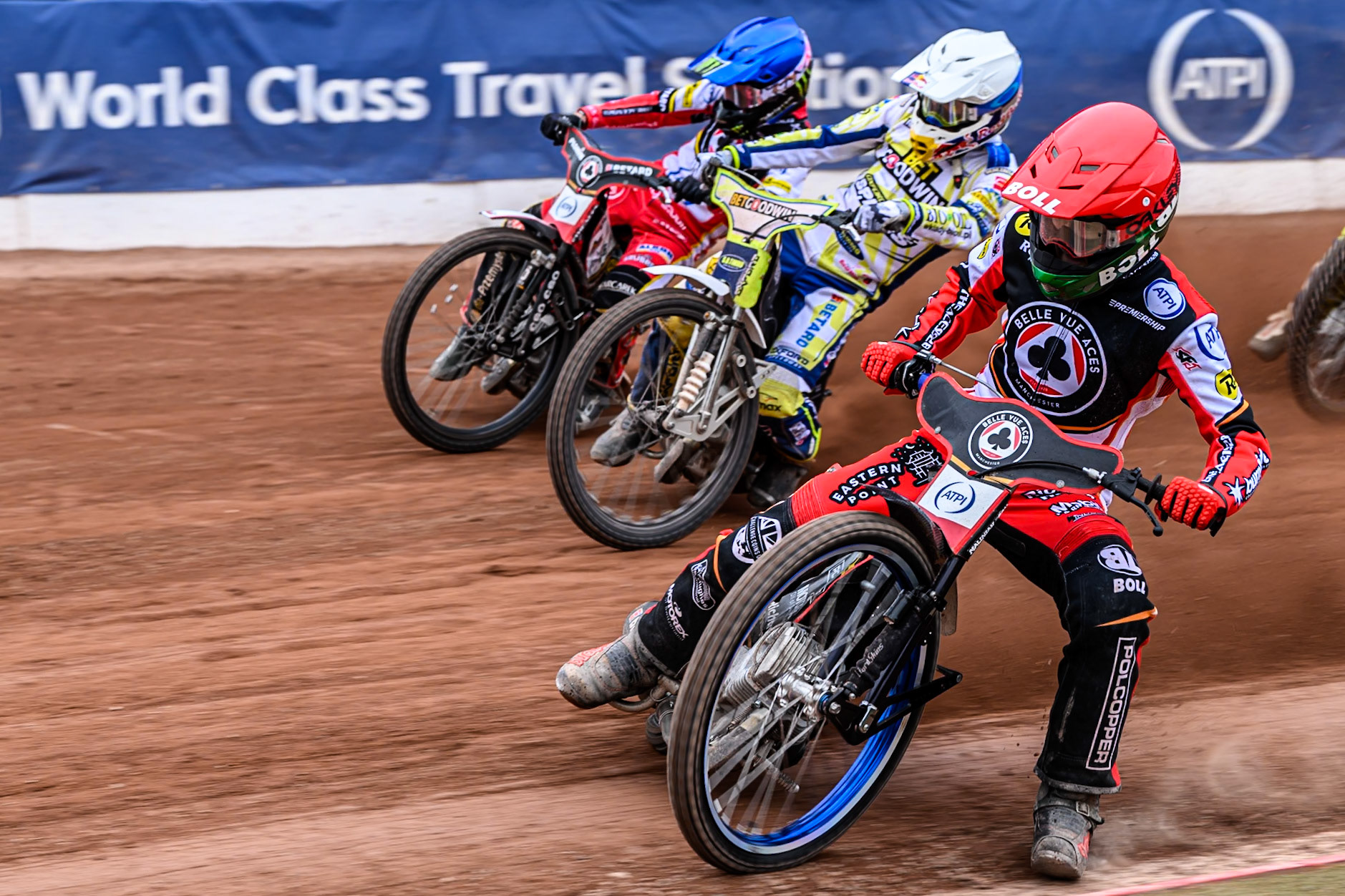 Belle Vue Aces' Brady Kurtz in Red rides inside Oxford Spires' Maciej Janowski in White and Belle Vue Aces' Dan Bewley in Blue during the Rowe Motor Oil Premiership match between Belle Vue Aces and Oxford Spires at the National Speedway Stadium, Manchester on Monday 26th May 2025. (Photo: Ian Charles | MI News)