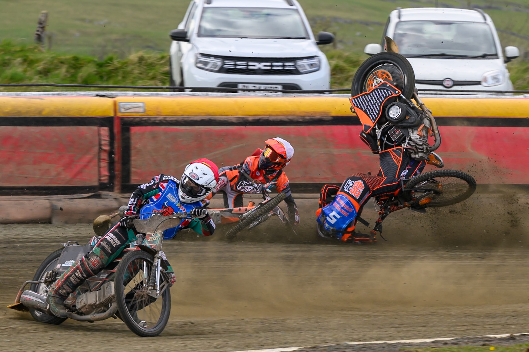 Connor Coles of NDL Nomads   in White fall and Jack Smith of Buxton Bulls   in Blue collides with him during the  Challenge match between Buxton Bulls and NDL Nomads at Hi-Edge Speedway, Buxton on Sunday 19th April 2026. (Photo: Ian Charles | MI News)