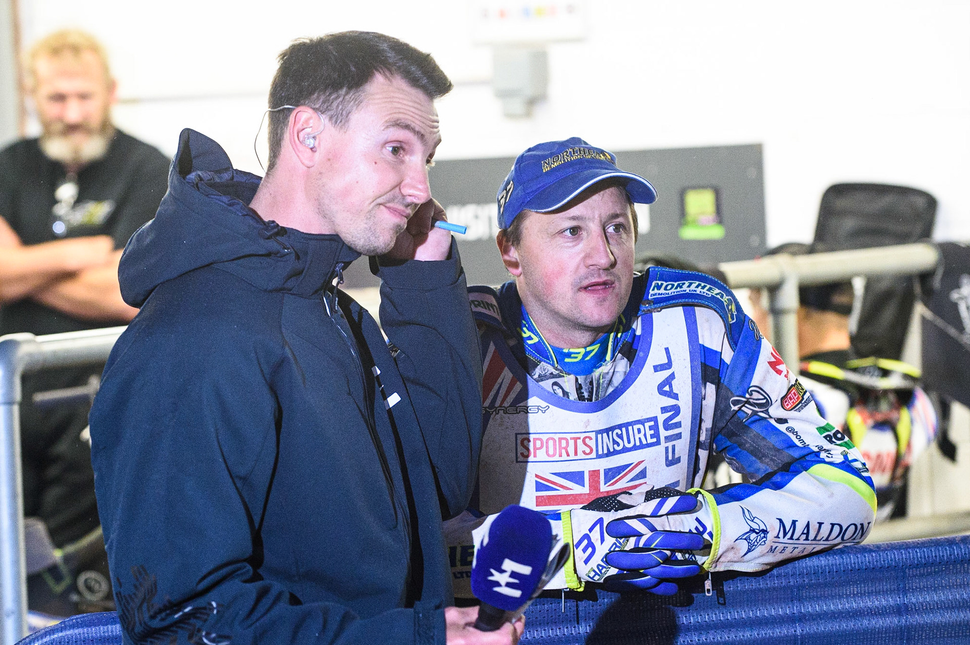 MANCHESTER, UK. AUGUST 16TH   Meeting co-presenter and racing analyst Simon Stead (left) watches the monitor with Chris Harris  during the Sports Insure British Speedway Finals at the National Speedway Stadium, Manchester on Monday 16th August 2021. (Credit: Ian Charles | MI News)