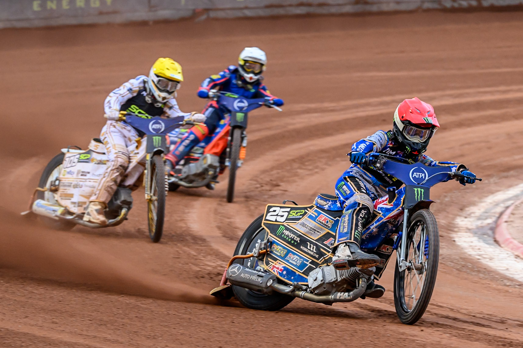 Jack Holder (25) of Australia in Red leading Anders Thomsen (105) of Denmark in Yellow and Andzejs Lebedevs (29) of Latvia in White during the ATPI FIM Speedway Grand Prix Round 4 at the National Speedway Stadium, Manchester, on Friday 13th June 2025. (Photo: Ian Charles | MI News)