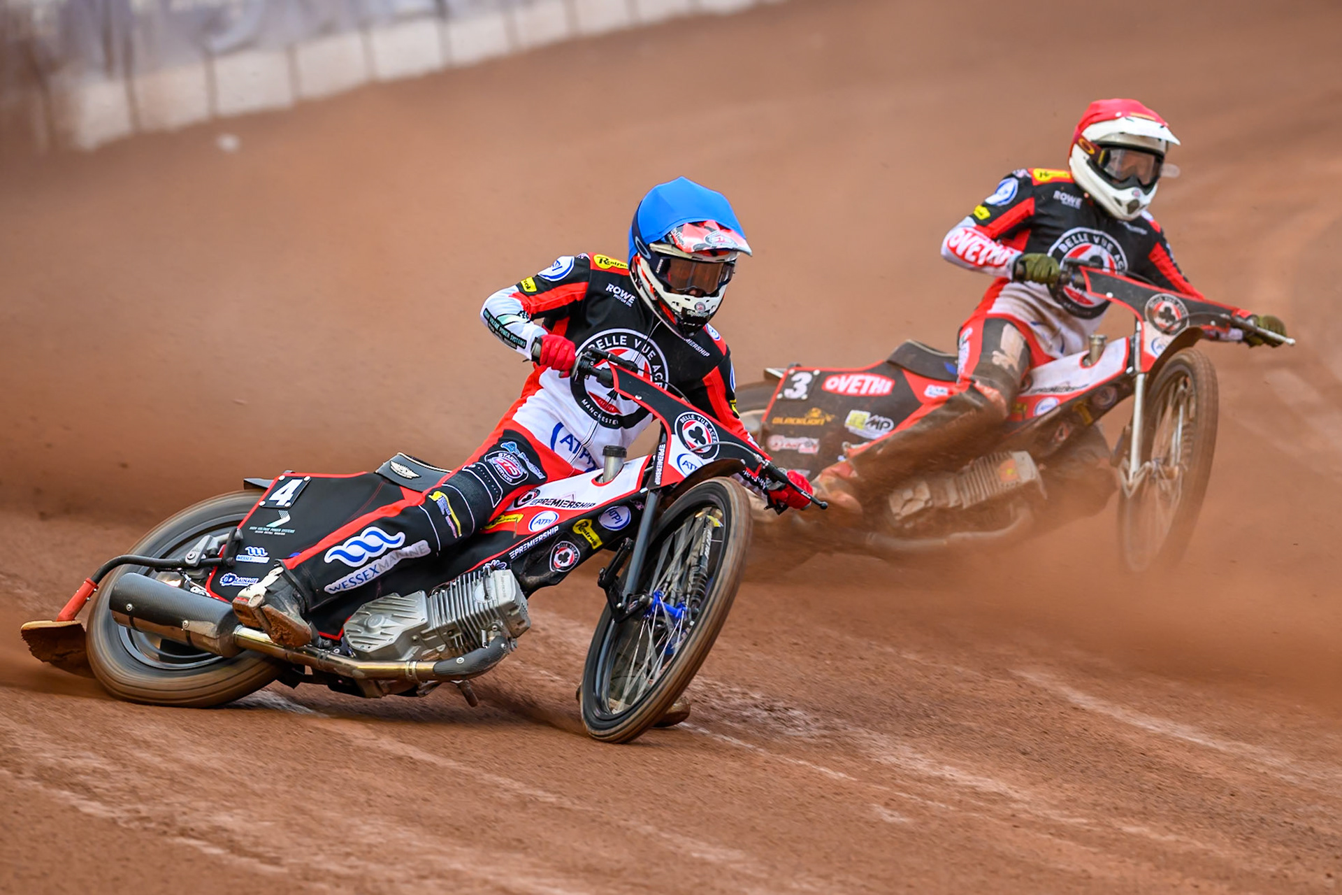 Zach Cook of Belle Vue Aces in Blue rides outside Peter Kildemand of Belle Vue Aces in Red during the Rowe Motor Oil Premiership match between Belle Vue Aces and Leicester Lions at the National Speedway Stadium, Manchester on Monday 15th June 2026. (Photo: Ian Charles | MI News)