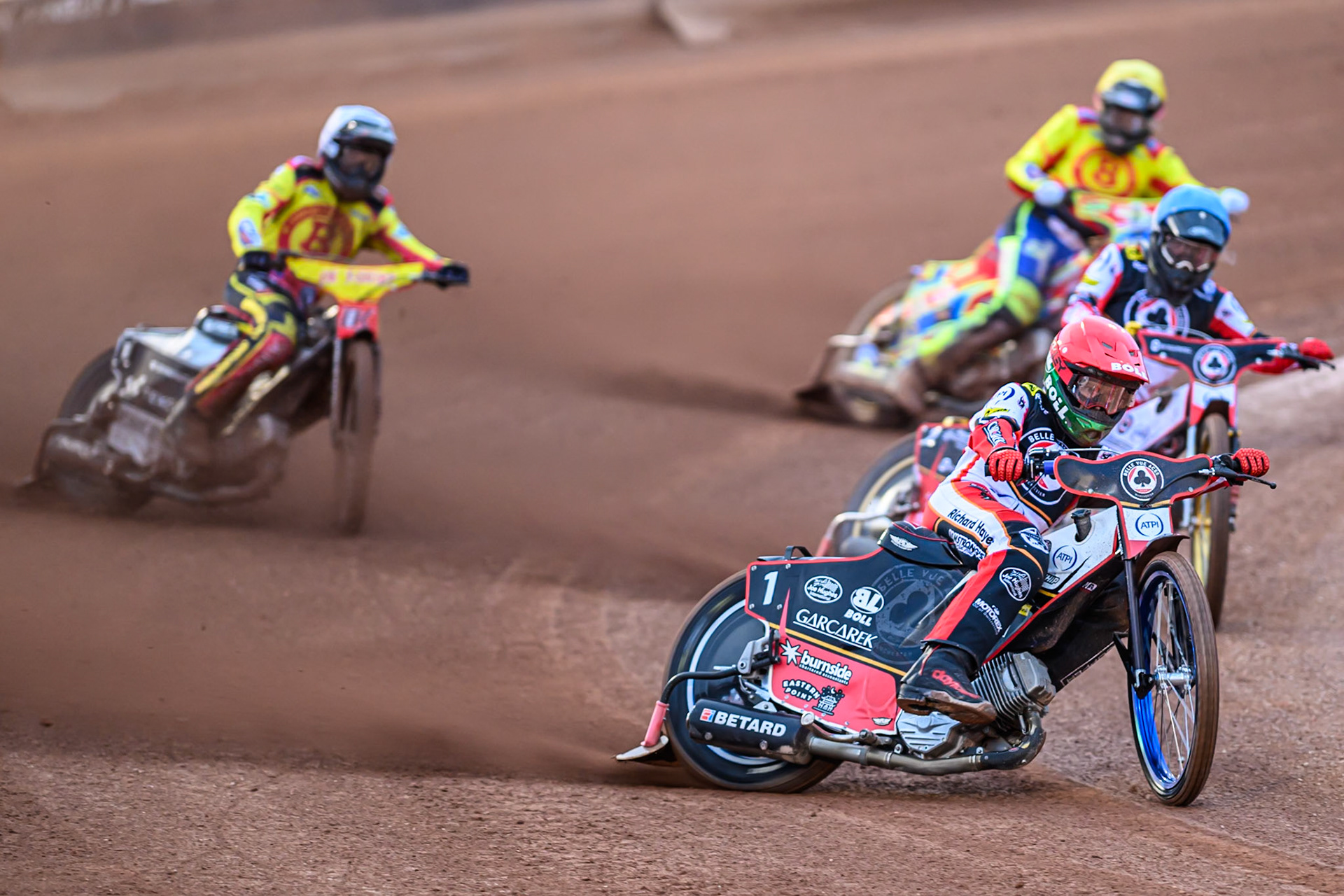 Brady Kurtz of Belle Vue Aces  in Red leading Norick Blödorn of Belle Vue Aces  in Blue, Tobias Musielak of Birmingham Brummies  in White and Simon Lambert, guest rider for Birmingham Brummies  in Yellow during the Rowe Motor Oil Premiership match between Belle Vue Aces and Birmingham Brummies at the National Speedway Stadium, Manchester on Monday 18th August 2025. (Photo: Ian Charles | MI News)