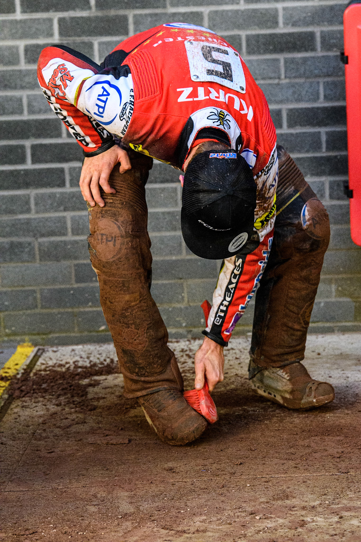 Brady Kurtz cleans the mud from his kevlars during the Sports Insure Premiership match between Belle Vue Aces and King's Lynn Stars at the National Speedway Stadium, Manchester on Monday 12th June 2023. (Photo: Ian Charles | MI News)