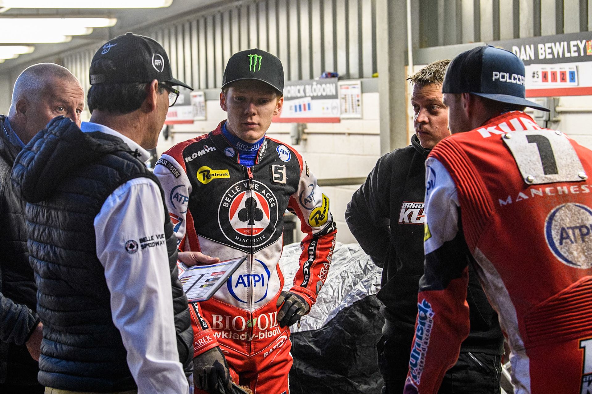 Belle Vue Aces' Team Manager Mark Lemon (Left) cheats with Belle Vue Aces' Dan Bewley (Centre) and Belle Vue Aces' Brady Kurtz (Right - Back to camera) during the Rowe Motor Oil Premiership match between Belle Vue Aces and Oxford Spires at the National Speedway Stadium, Manchester on Monday 13th May 2024. (Photo: Ian Charles | MI News)