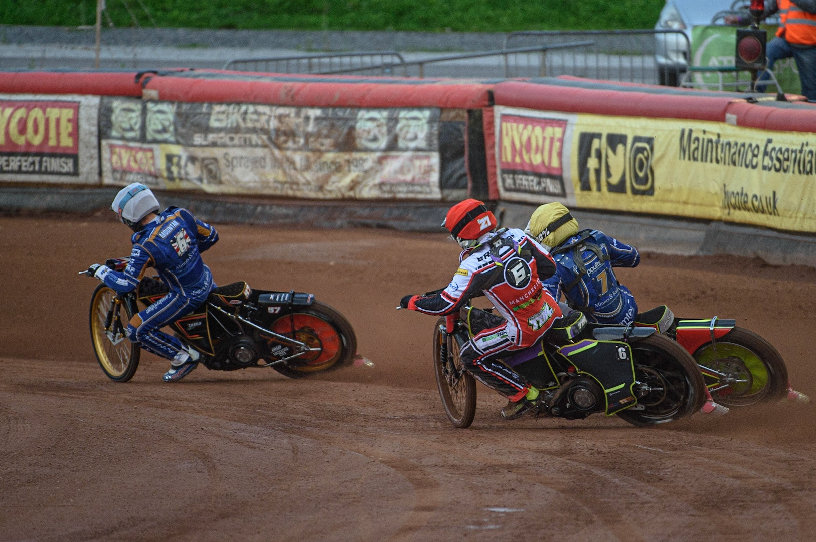 MANCHESTER, UK. AUGUST 23RD    Tom Brennan  (Red) chases Kasper Andersen  (Yellow) and Connor Mountain  (White) during the SGB Premiership match between Belle Vue Aces and King's Lynn Stars at the National Speedway Stadium, Manchester on Monday 23rd August 2021. (Credit: Ian Charles | MI News)