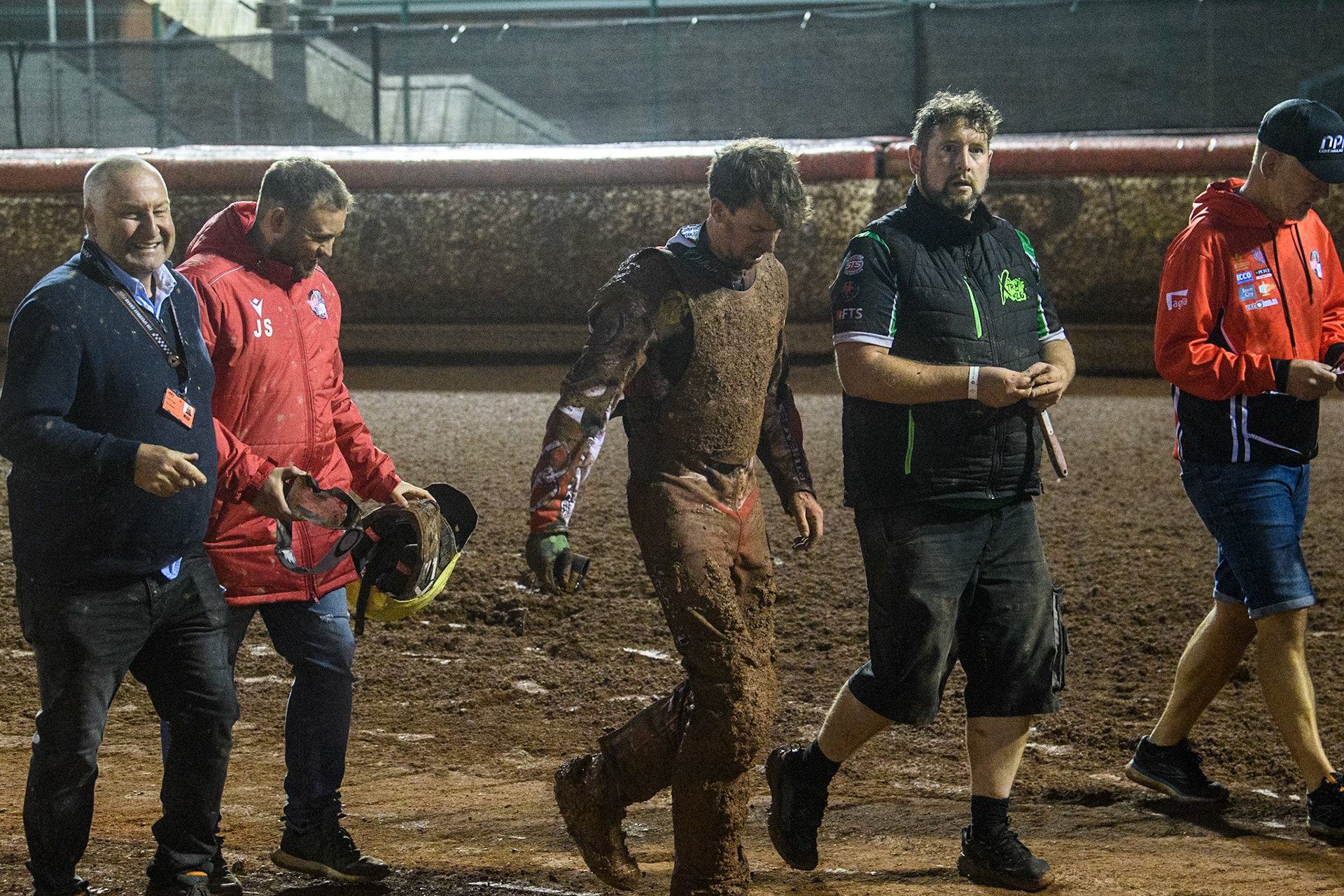 Charles Wright  (Centre0 walks back to the pits after his fall with track officials and members of his team during the Sports Insure British Speedway Final at the National Speedway Stadium, Manchester on Monday 14th August 2023. (Photo: Ian Charles | MI News)