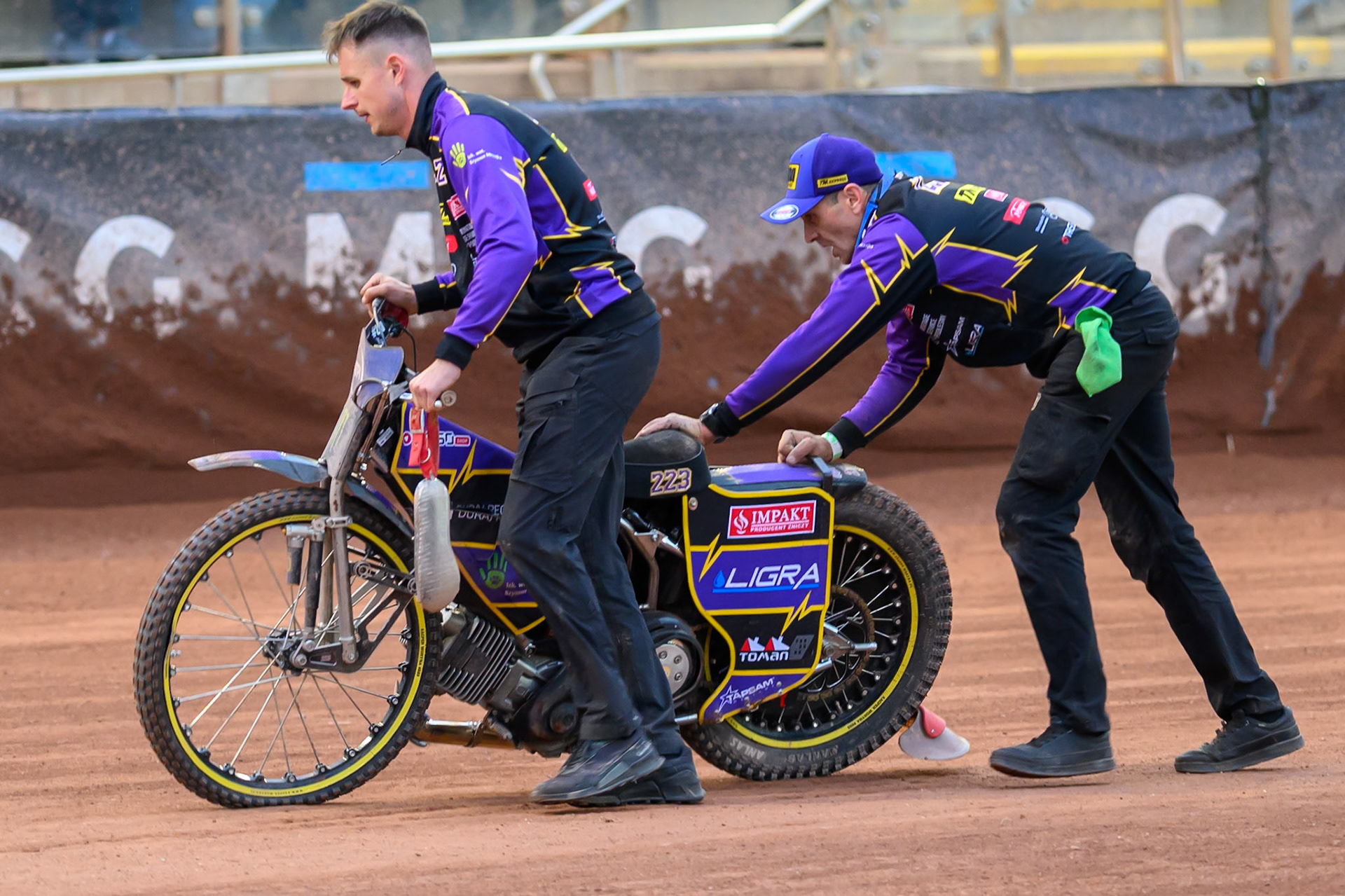 Kacper Woryna's mechanics push his bike back after his Heat 18 crash during the ATPI  FIM Speedway GP of Manchester at the National Speedway Stadium, Manchester on Friday 5th June 2026. (Photo: Ian Charles | MI News)
