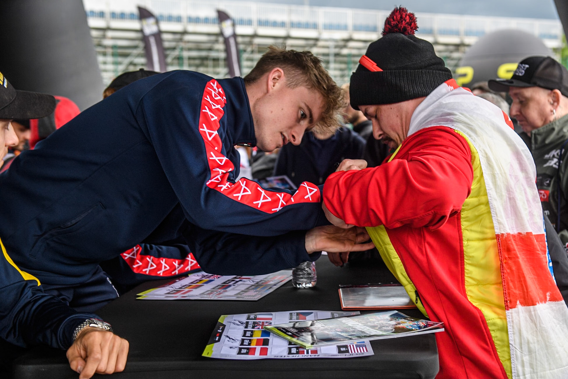 Tom Brennan of Great Britain signs a fans flag at the Autograph session in the FanZone during the Monster Energy FIM Speedway of Nation Final at the National Speedway Stadium, Manchester on Saturday 13th July 2024. (Photo: Ian Charles | MI News)