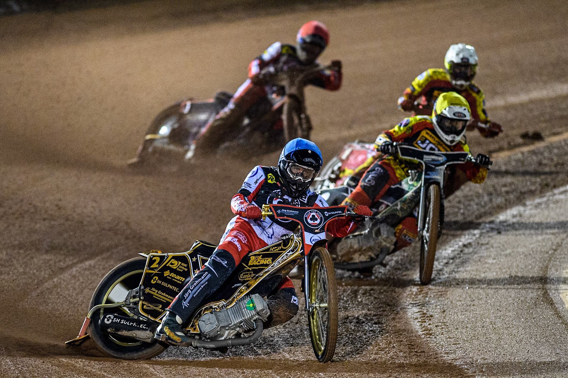 Belle Vue Aces' Norick Blodorn  in Blue leading Leicester Lions' Richard Lawson  in Yellow, Leicester Lions' Max Fricke  in White and Belle Vue Aces' Brady Kurtz  in Red during the Rowe Motor Oil Premiership Grand Final 1st Leg between Belle Vue Aces and Leicester Lions at the National Speedway Stadium, Manchester on Monday 23rd September 2024. (Photo: Ian Charles | MI News)