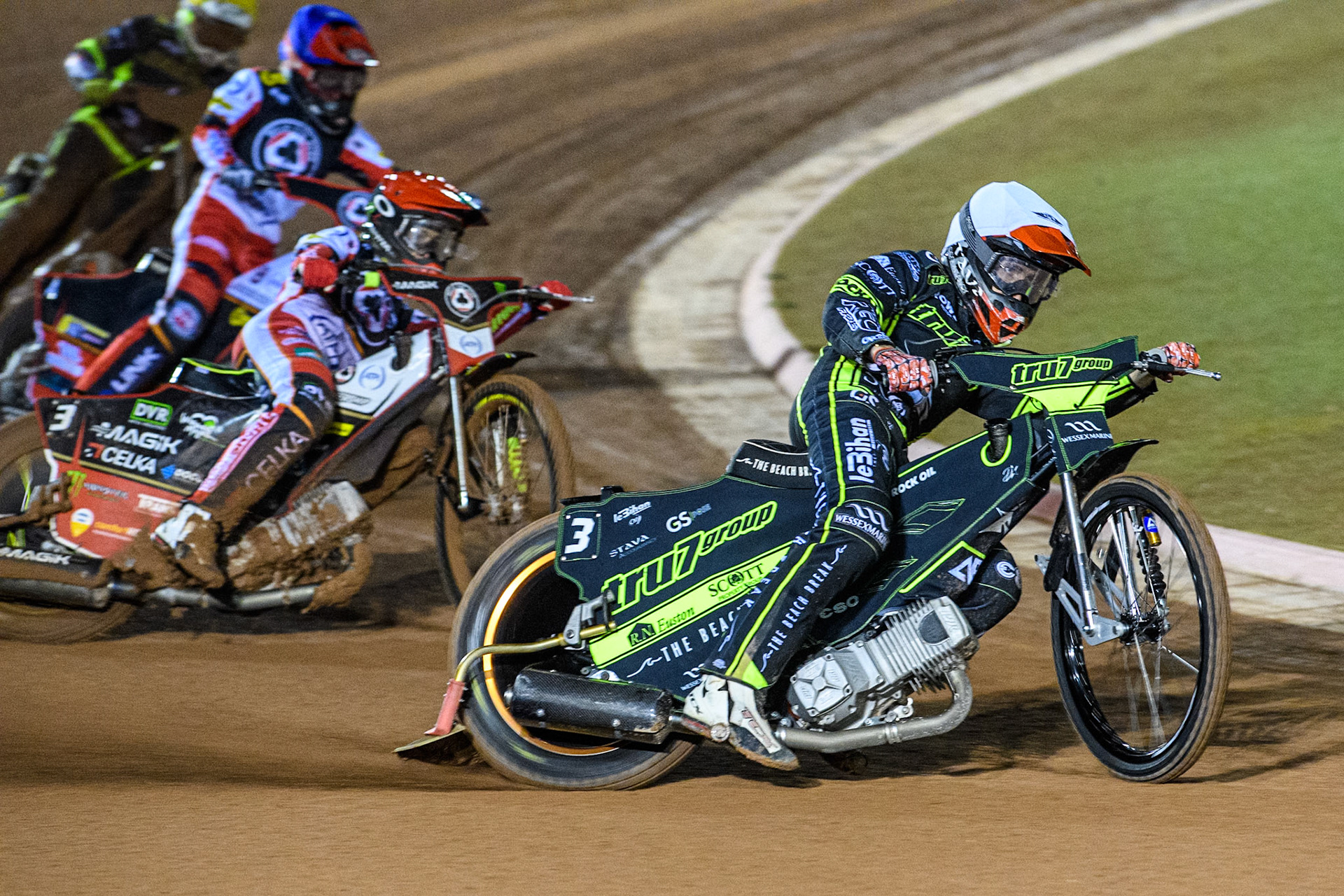 Adam Ellis of Ipswich Witches leading Jaimon Lidsey of Belle Vue Aces in Red and Zach Cook of Belle Vue Aces in Blue during the Premiership Cup Quarter Final 1st Leg match between Belle Vue Aces and Ipswich Witches at the National Speedway Stadium, Manchester on Monday 24th March 2025. (Photo: Ian Charles | MI News)