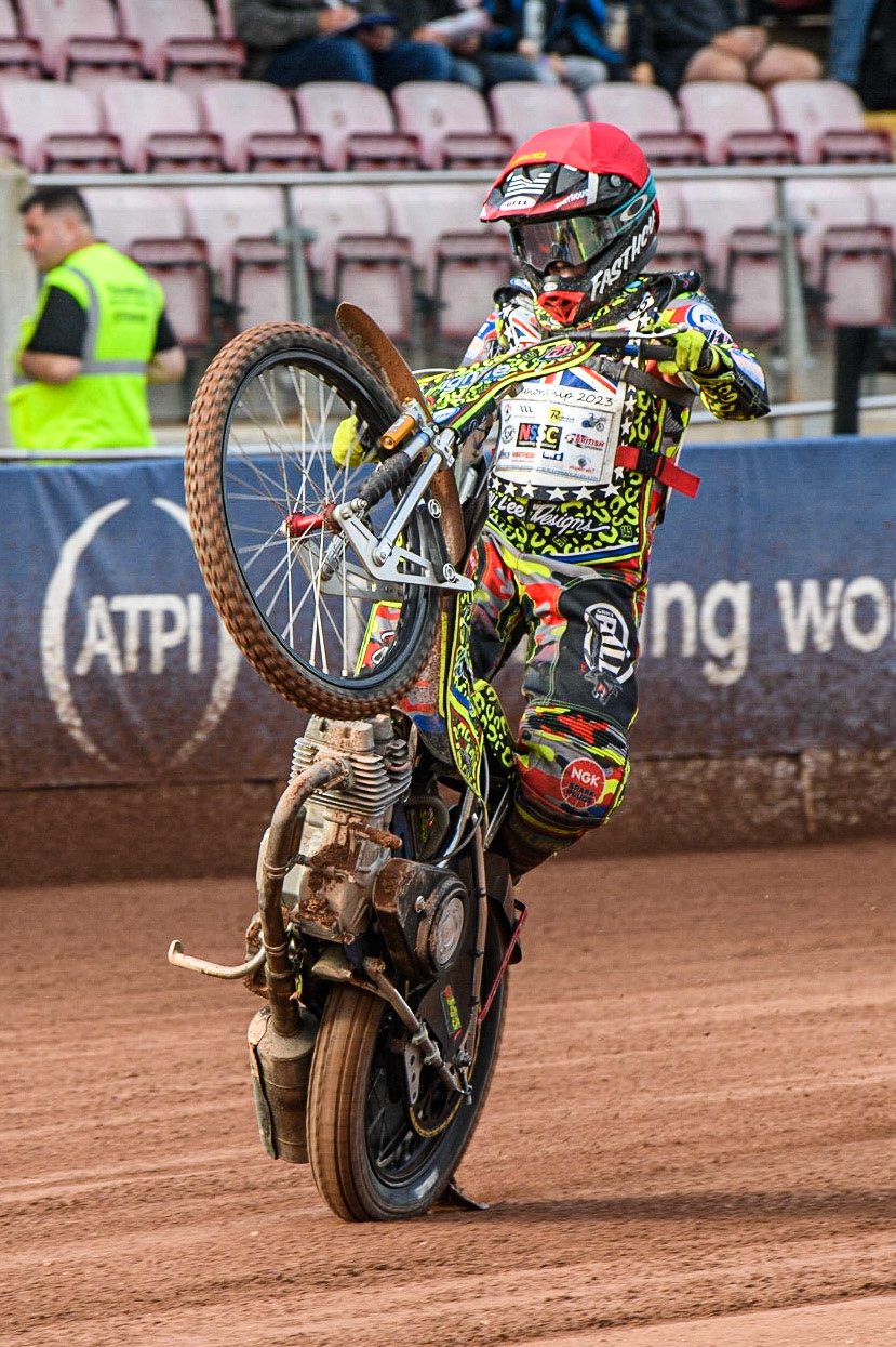 William Cairns celebrates with a wheelie after his heat win gives him the overall 250cc British Junior Championship during the British Youth Speedway Championships at the National Speedway Stadium, Manchester on Friday 21st July 2023. (Photo: Ian Charles | MI News)