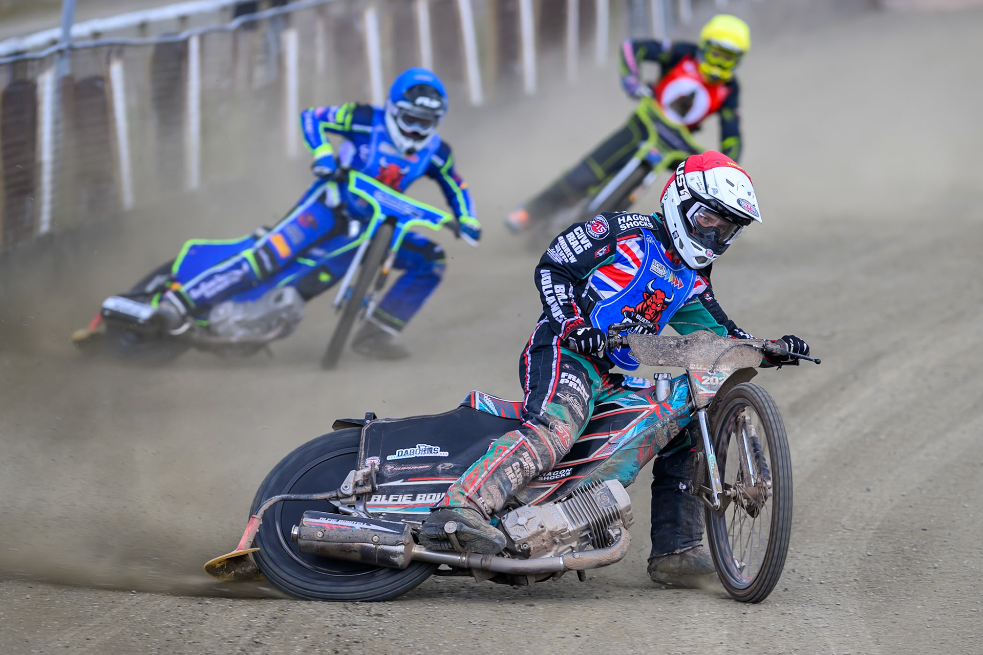 Alfie Bowtell of Buxton Bulls  in Red leading Arran Butcher of Buxton Bulls  in Blue and Ben Whalley of NDL Nomads   in Yellow during the  Challenge match between Buxton Bulls and NDL Nomads at Hi-Edge Speedway, Buxton on Sunday 19th April 2026. (Photo: Ian Charles | MI News)