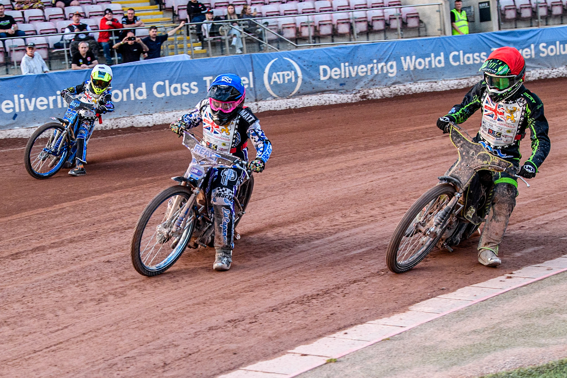 Charlie Southwick (250cc) in Red rides inside Liam Morris (250cc) in Blue and Jayden Bailey (250cc) in White during the British Youth 250cc Championships at the National Speedway Stadium, Manchester on Friday 30th August 2024. (Photo: Ian Charles | MI News)