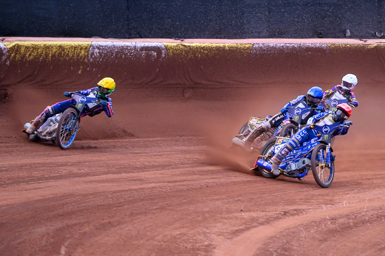 Brady Kurtz (101) of Australia in Yellow goes wide leading Bartosz Zmarzlik (95) of Poland in Red, Jack Holder (25) of Australia in Blue and Kacper Woryna (223) of Poland in White during the ATPI  FIM Speedway GP of Manchester at the National Speedway Stadium, Manchester on Saturday 6th June 2026. (Photo: Ian Charles | MI News)