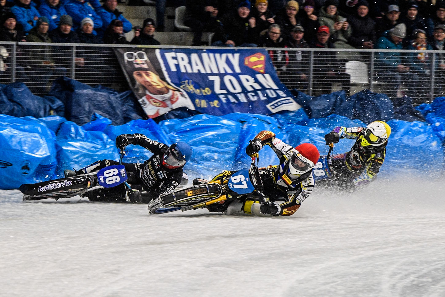 Heikki Huusko (67) of Finland in Red rides inside Aki Ala-Riihimäki (66) of Finland in Blue with Max Niedermaier  (88) of Germany in White behind during the Ice Speedway Gladiators World Championship Final 2 at Max-Aicher-Arena, Inzell on Sunday 16th March 2025. (Photo: Ian Charles | MI News)