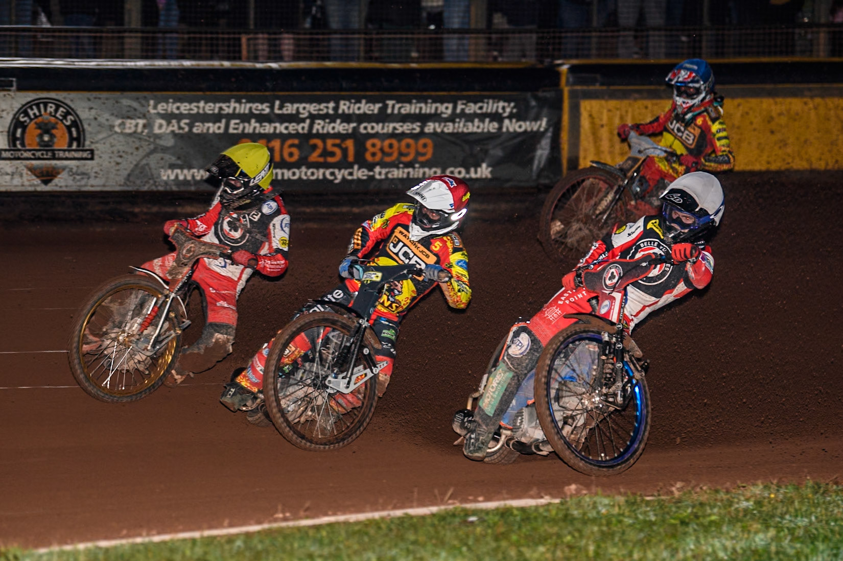Belle Vue Aces' Brady Kurtz in White and Belle Vue Aces' Norick Blodorn in Yellow in their title winning heat 10 go either side of Leicester Lions' Ryan Douglas in Red  during the Rowe Motor Oil Premiership Grand Final 2nd Leg between Leicester Lions and Belle Vue Aces at the Pidcock Motorcycles Arena, Leicester on Thursday 26th September 2024. (Photo: Ian Charles | MI News)