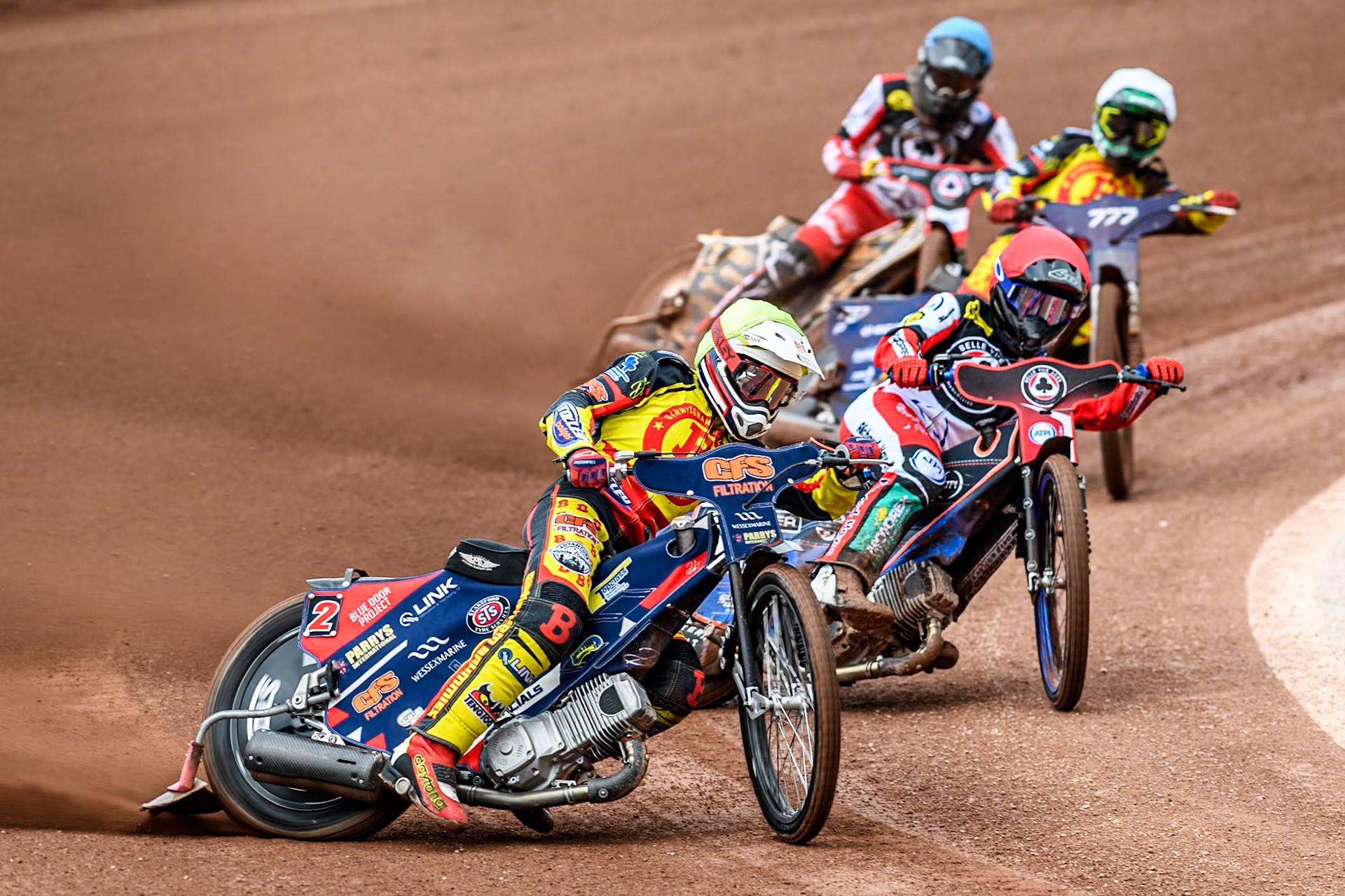 Birmingham Brummies' Steve Worrall  in Yellow leading Belle Vue Aces' Brady Kurtz  in Red, Birmingham Brummies' Piotr Pawlicki  in White and Belle Vue Aces' Norick Blödorn  in Blue during the Rowe Motor Oil Premiership match between Belle Vue Aces and Birmingham Brummies at the National Speedway Stadium, Manchester on Monday 6th May 2024. (Photo: Ian Charles | MI News)