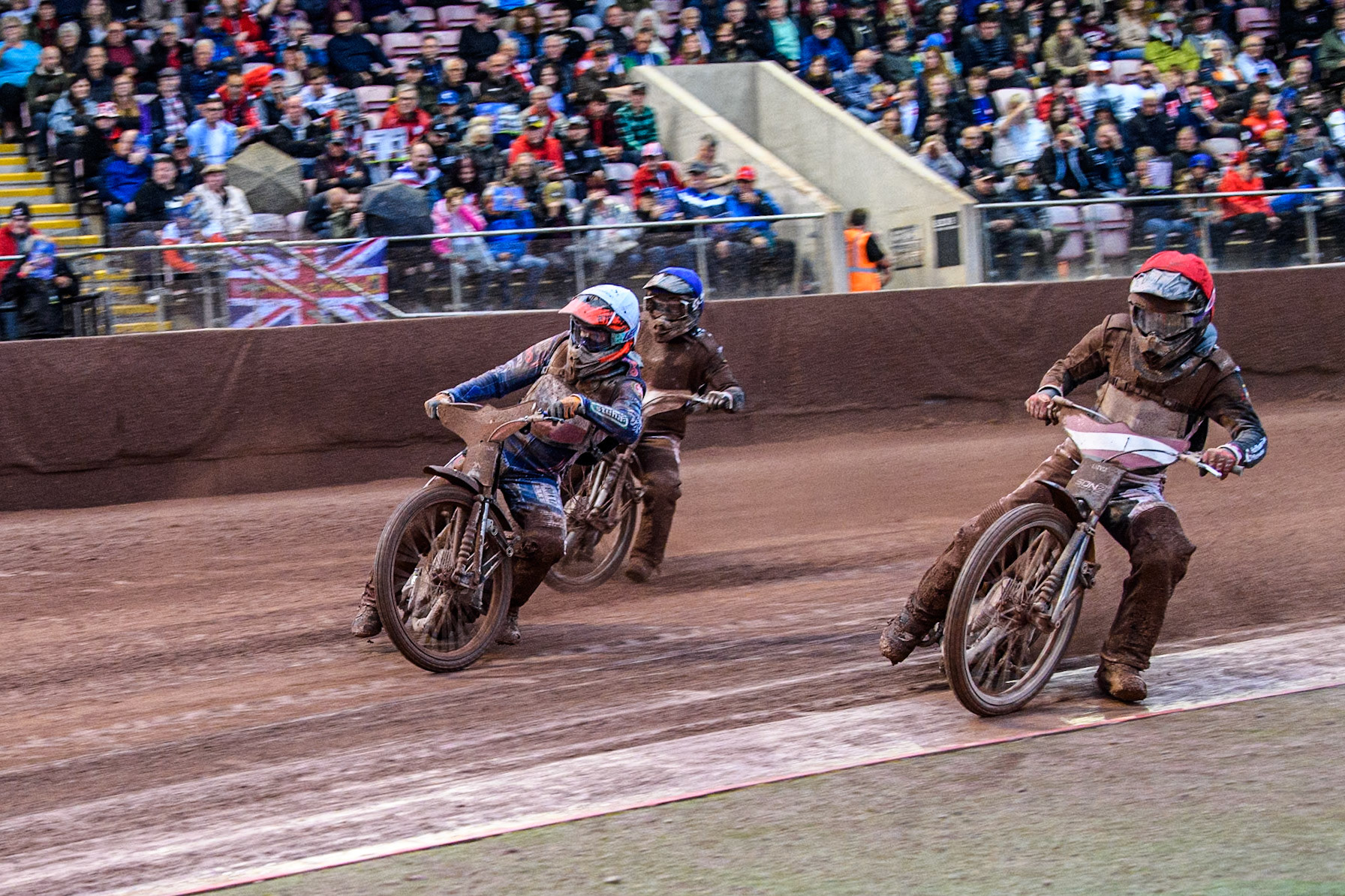 Artjoms Juhno of Latvia in Red rides inside Jan Jenicek of Czech Republic in White with Nikita Kaulins of Latvia in Blue behind during the Monster Energy FIM Speedway of Nations 2 (Under 21) Final at the National Speedway Stadium, Manchester on Friday 12th July 2024. (Photo: Ian Charles | MI News)