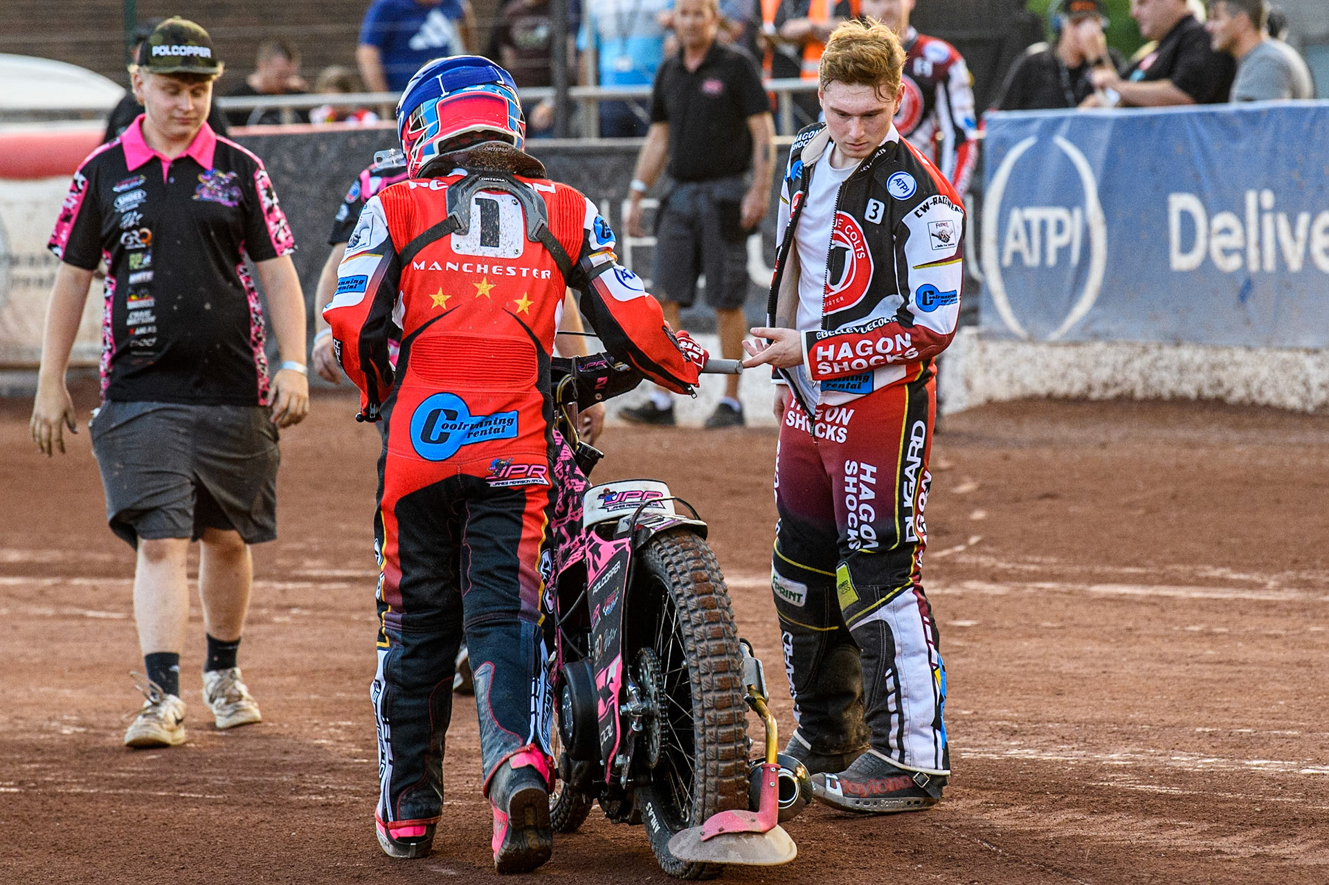 James Pearson pushes his bike back to the pits after his machine failure with Sam Hagon (right) offering help during the National Development League match between Belle Vue Colts and Kent Royals at the National Speedway Stadium, Manchester on Friday 7th July 2023. (Photo: Ian Charles | MI News)