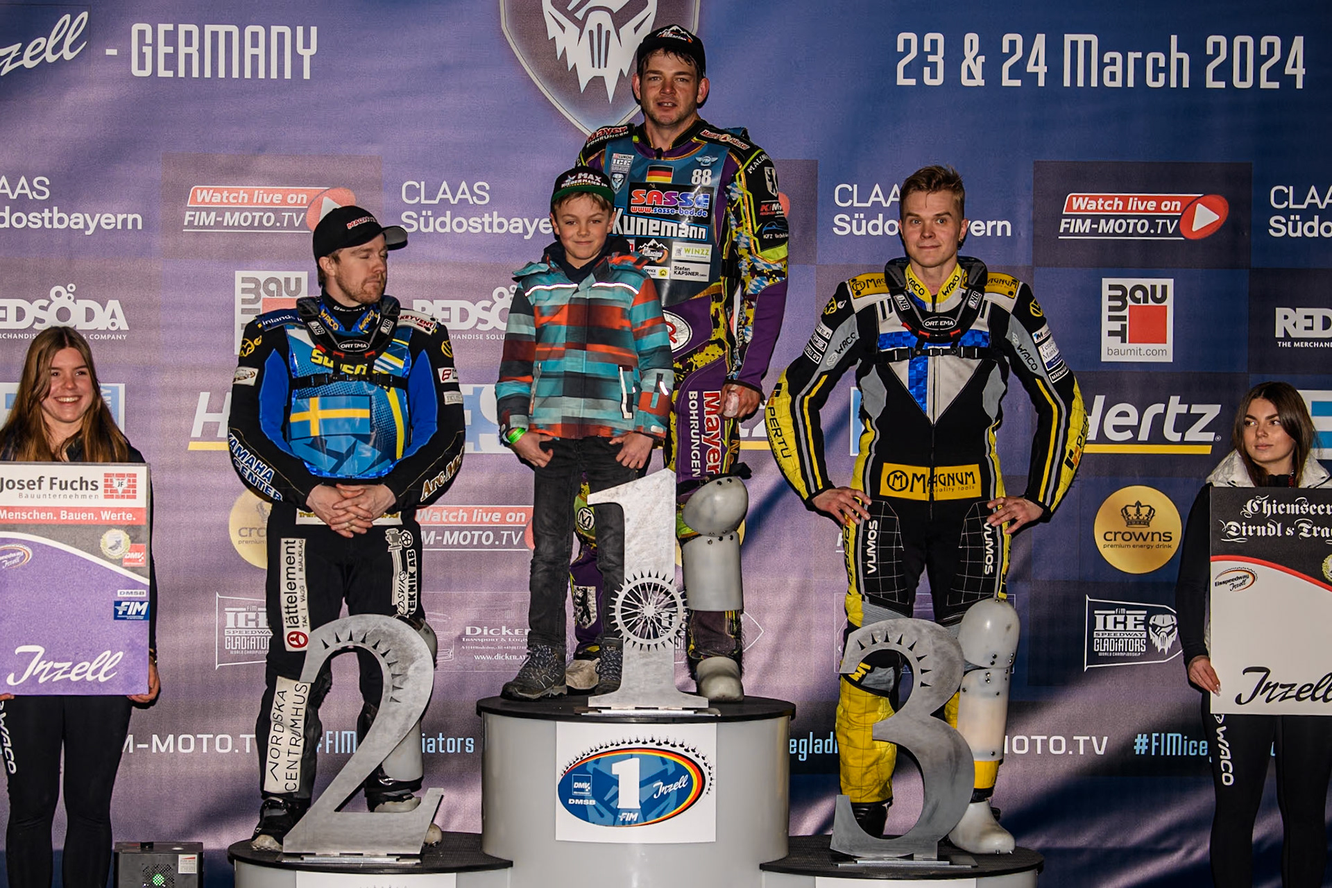 Top 3: (L to R) Sweden's Martin Haarahiltunen (2nd) Germany's Max Niedermaier (1st) (with his son), Finland's Heikki Huusko (3rd) during the FIM Ice Speedway Gladiators World Championship Final 1 at the Max-Aicher-Arena, Inzell on Saturday 23 March 2024. (Photo: Ian Charles | MI News)