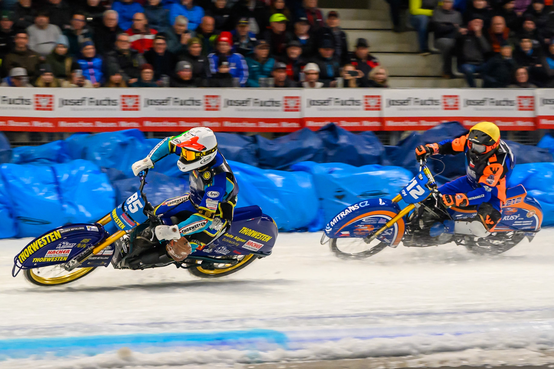 Luca Bauer (85) of Italy/Germany in White leading Lukas Hutla (212) of Czechia in Yellow during the Ice Speedway Gladiators World Championship Final 2 at Max-Aicher-Arena, Inzell on Sunday 15th March 2026. (Photo: Ian Charles | MI News)