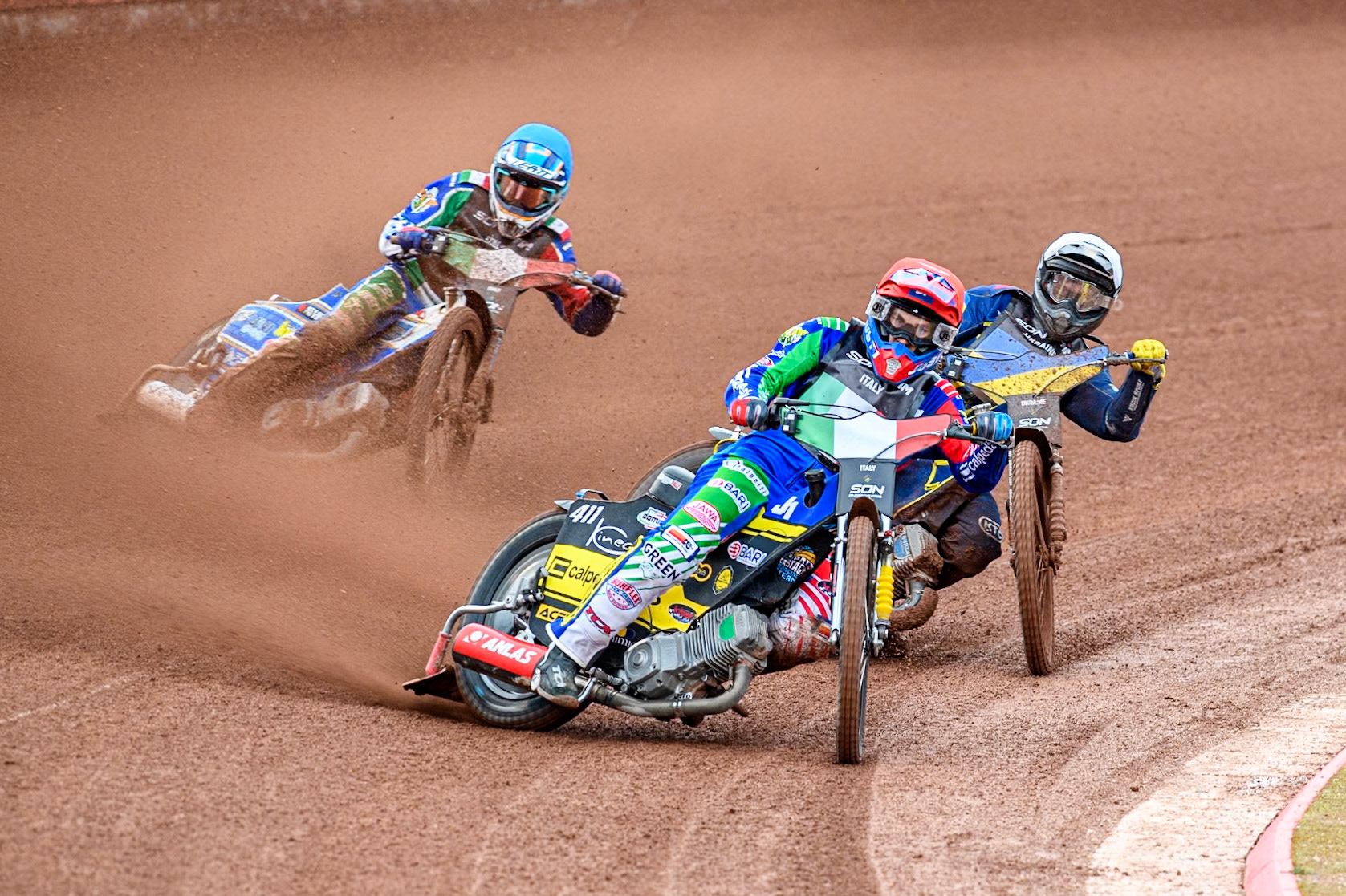 Paco Castagna of Italy in Red leading Stanislav Melnychuk of Ukraine in White and Nicolas Covatti of Italy in Blue during the Monster Energy FIM Speedway of Nations Semi-Final 1 at the National Speedway Stadium, Manchester on Tuesday 9th July 2024. (Photo: Ian Charles | MI News)