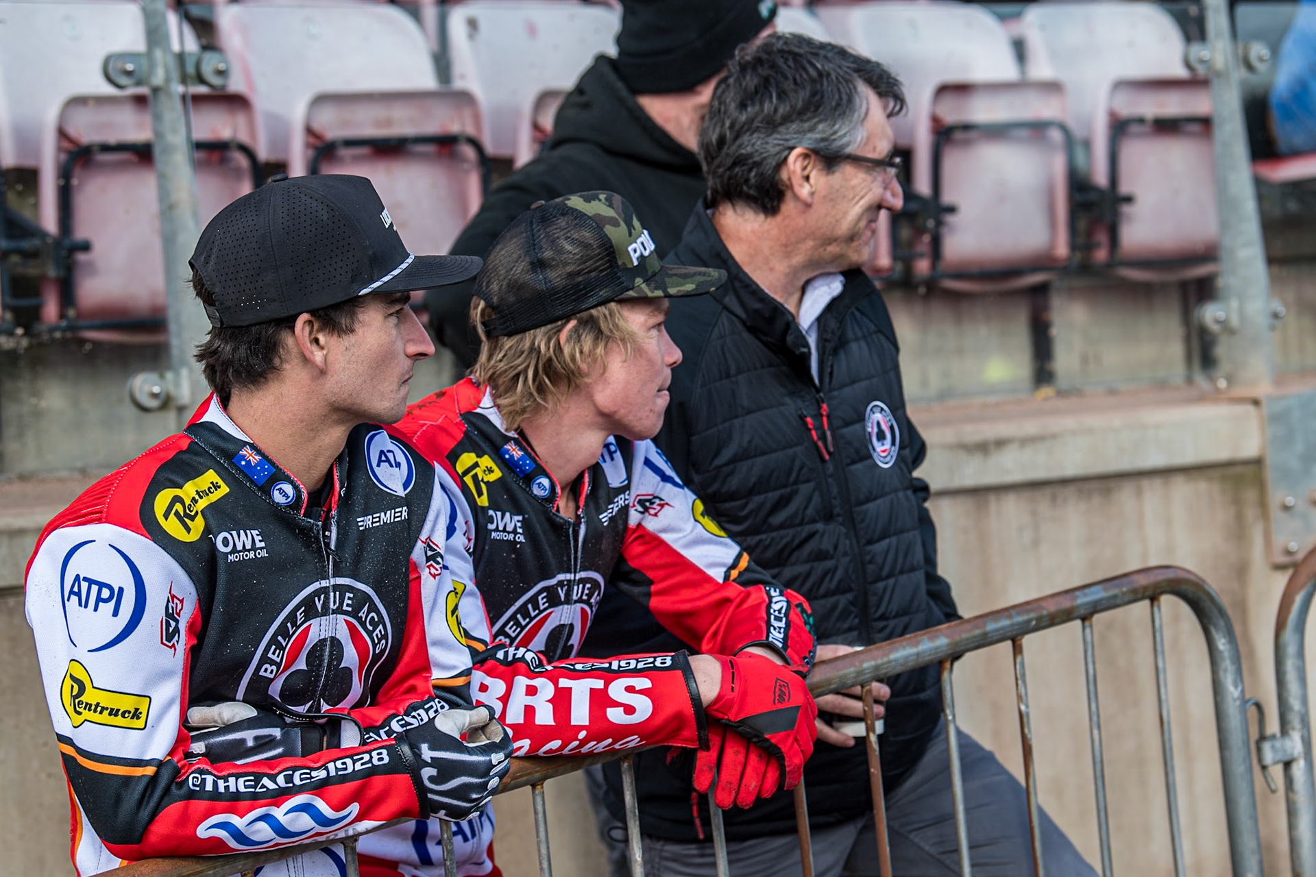 (L to R) Zack Cook, Tate Zischke and Mark Lemon, Belle Vue Aces Team Manager watch the practice session during the Belle Vue Aces Media Day at the National Speedway Stadium, Manchester on Wednesday 12th March 2025. (Photo: Ian Charles | MI News)