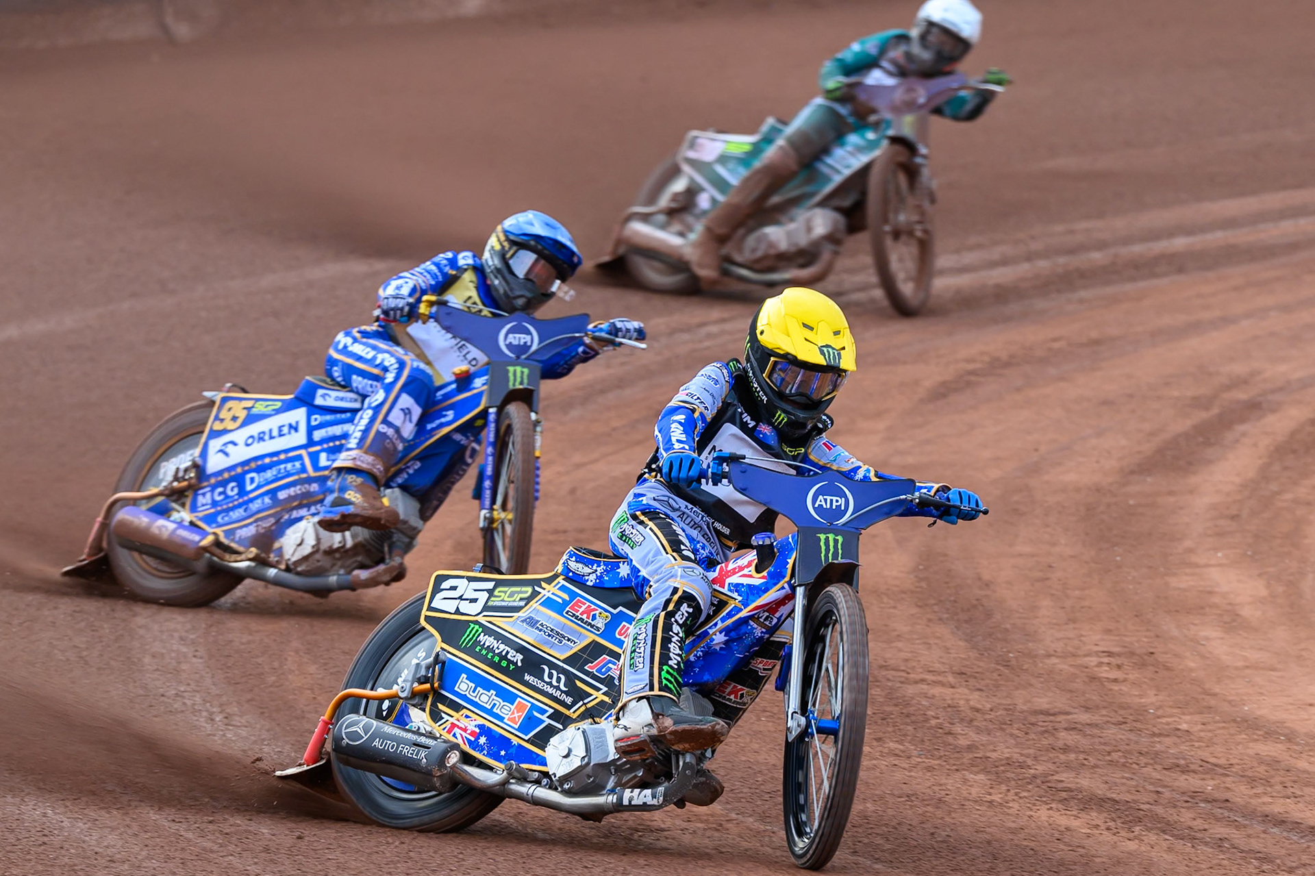 Jack Holder (25) of Australia in Yellow leading Bartosz Zmarzlik (95) of Poland  in Blue and Leon Madsen (30) of Denmark in White during the ATPI  FIM Speedway GP of Manchester at the National Speedway Stadium, Manchester on Friday 5th June 2026. (Photo: Ian Charles | MI News)