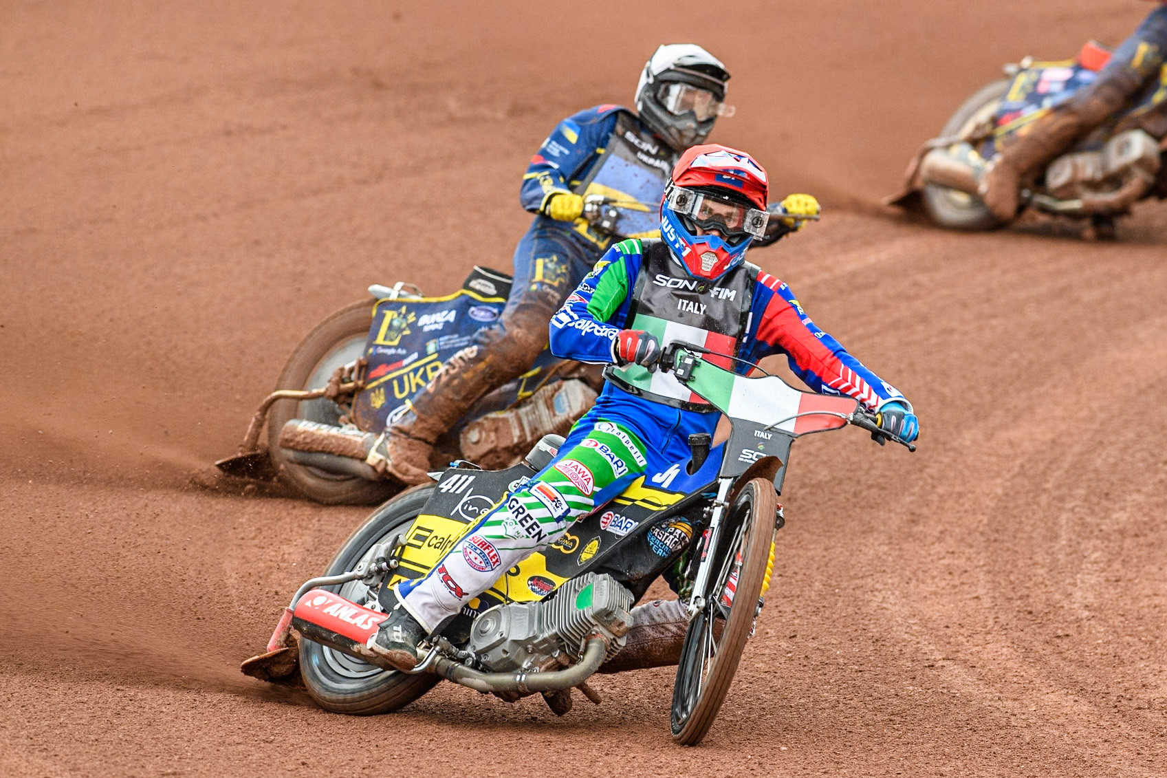Paco Castagna of Italy in Red leading Stanislav Melnychuk of Ukraine in White during the Monster Energy FIM Speedway of Nations Semi-Final 1 at the National Speedway Stadium, Manchester on Tuesday 9th July 2024. (Photo: Ian Charles | MI News)