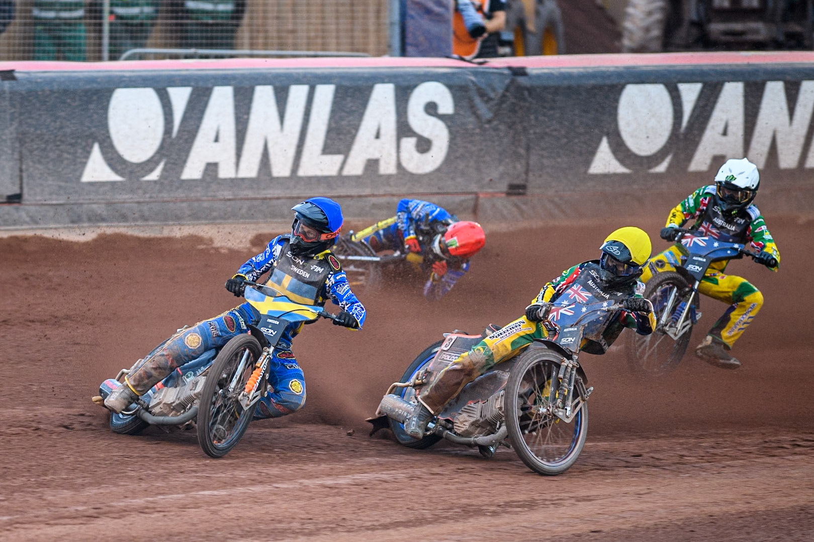 SWEDEN v AUSTRALIA: Jacob Thorssell of Sweden in Blue leading Brady Kurtz of Australia in Yellow and Jack Holder of Australia in White as Fredrik Lindgren of Sweden in Red slides off in the dirt during the Monster Energy FIM Speedway of Nation Final at the National Speedway Stadium, Manchester on Saturday 13th July 2024. (Photo: Ian Charles | MI News)
