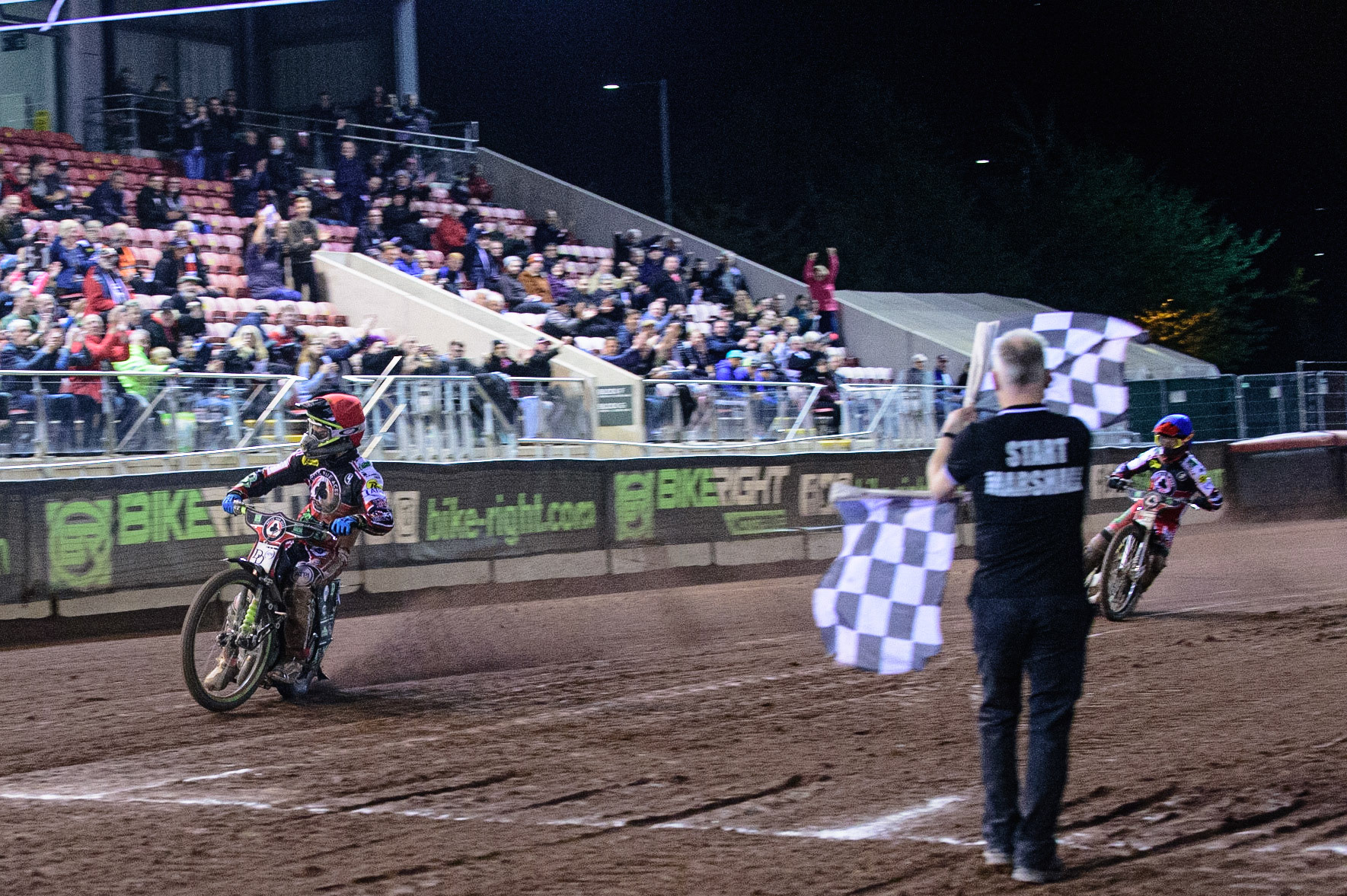MANCHESTER, UK. OCT 7TH  Charles Wright  (Red) wins heat 14 with Jye Etheridge  (Blue) in second place to give the aggregate win to the Aces with one heat remaining during the SGB Premiership Play off Semi-Final Second Leg between Belle Vue Aces and Sheffield Tigers at the National Speedway Stadium, Manchester on Thursday 7th October 2021. (Credit: Ian Charles | MI News)