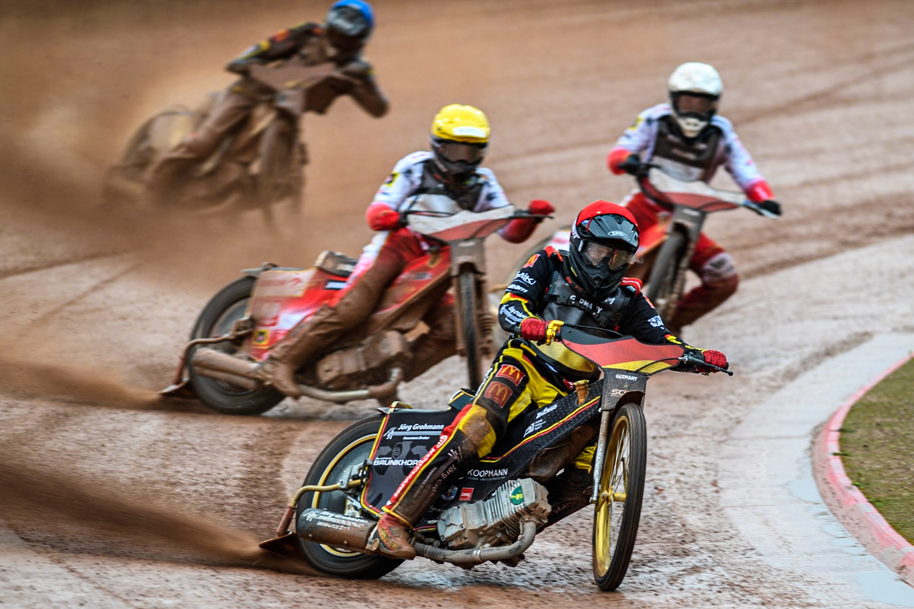 Norick Blödorn of Germany in Red leading Wiktor Przyjemski of Poland in White, Bartosz Banbor of Poland in Yellow and Jonny Wynant of Germany in Blue during the Monster Energy FIM Speedway of Nations 2 (Under 21) Final at the National Speedway Stadium, Manchester on Friday 12th July 2024. (Photo: Ian Charles | MI News)