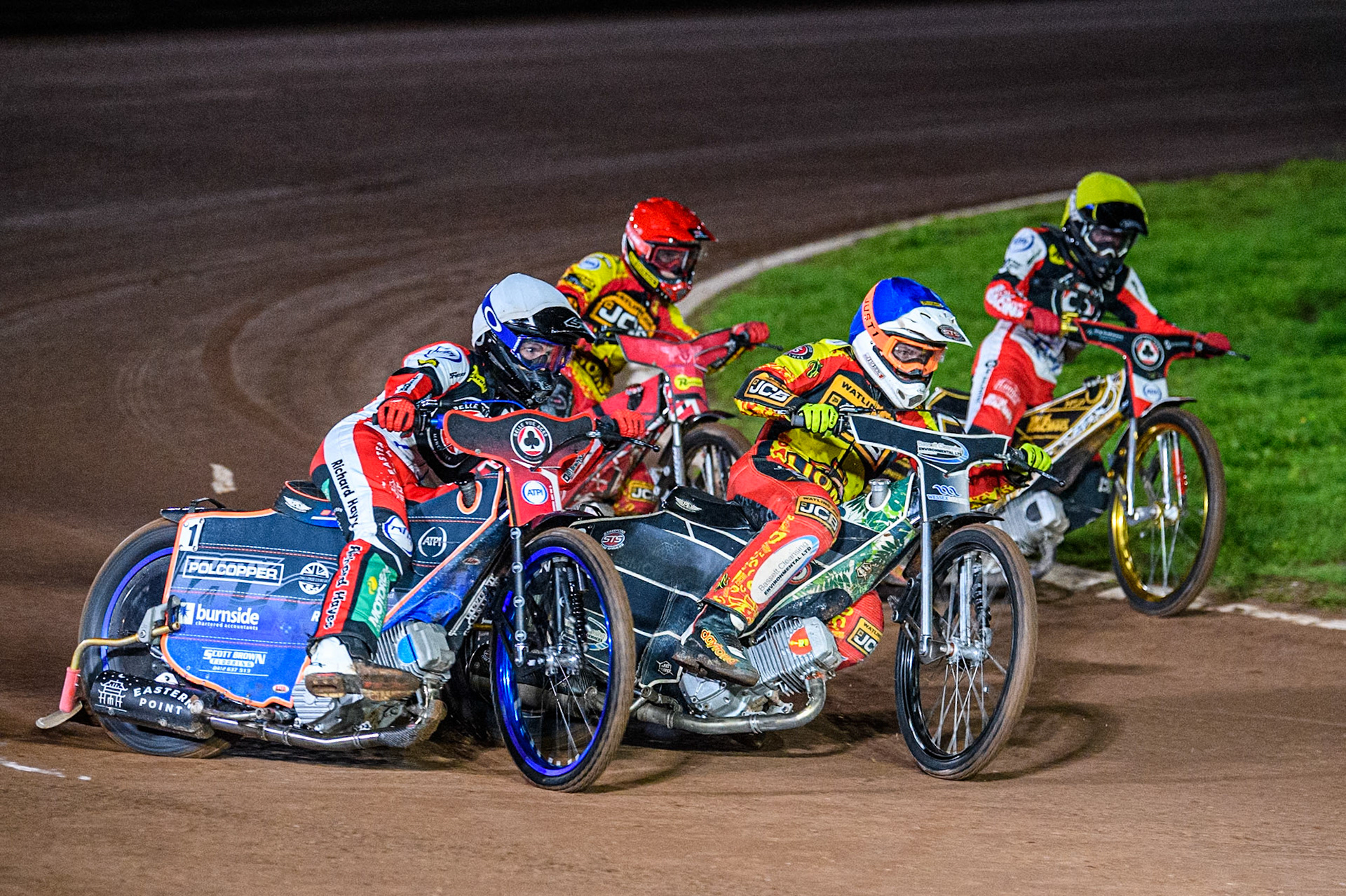 Belle Vue Aces' Brady Kurtz in White rides outside Leicester Lions' Richard Lawson in Blue, Leicester Lions' Max Fricke in Red and Belle Vue Aces' Norick Blodorn in Yellow during the Rowe Motor Oil Premiership Grand Final 2nd Leg between Leicester Lions and Belle Vue Aces at the Pidcock Motorcycles Arena, Leicester on Thursday 26th September 2024. (Photo: Ian Charles | MI News)