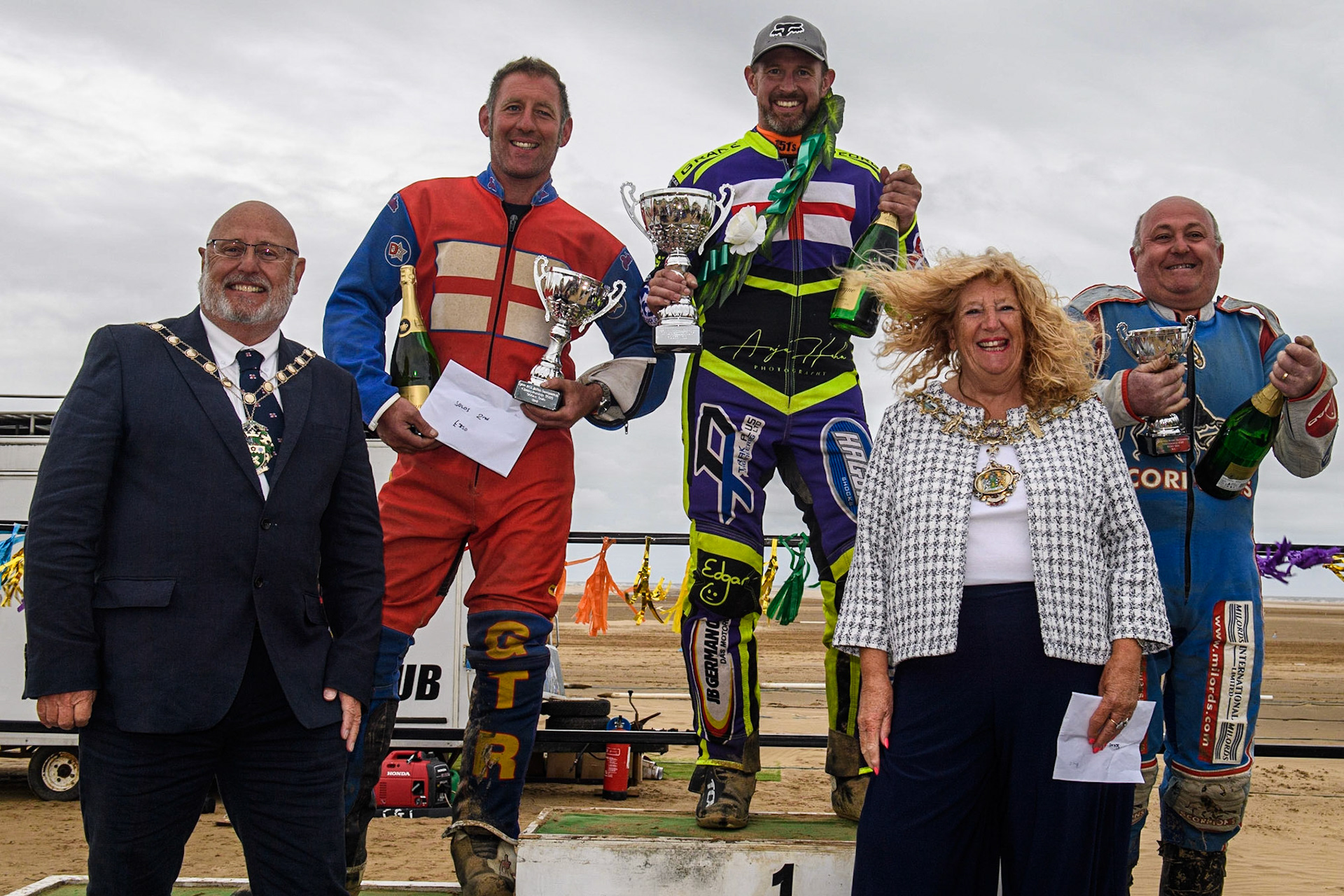 Solos Top 3: (l - r) Daniel Winterton (12) (2nd), Paul Cooper (11) (Winner) Mark Wrathall (29) (3rd).  Foreground Cllr Cheryl Little, The Worshipful Mayer of Fylde (right) with her Consort.during the Fylde ACU British Sand Racing Masters Championship at  St Annes on Sea, Lancashire on Sunday 30th July 2023. (Photo: Ian Charles | MI News)
