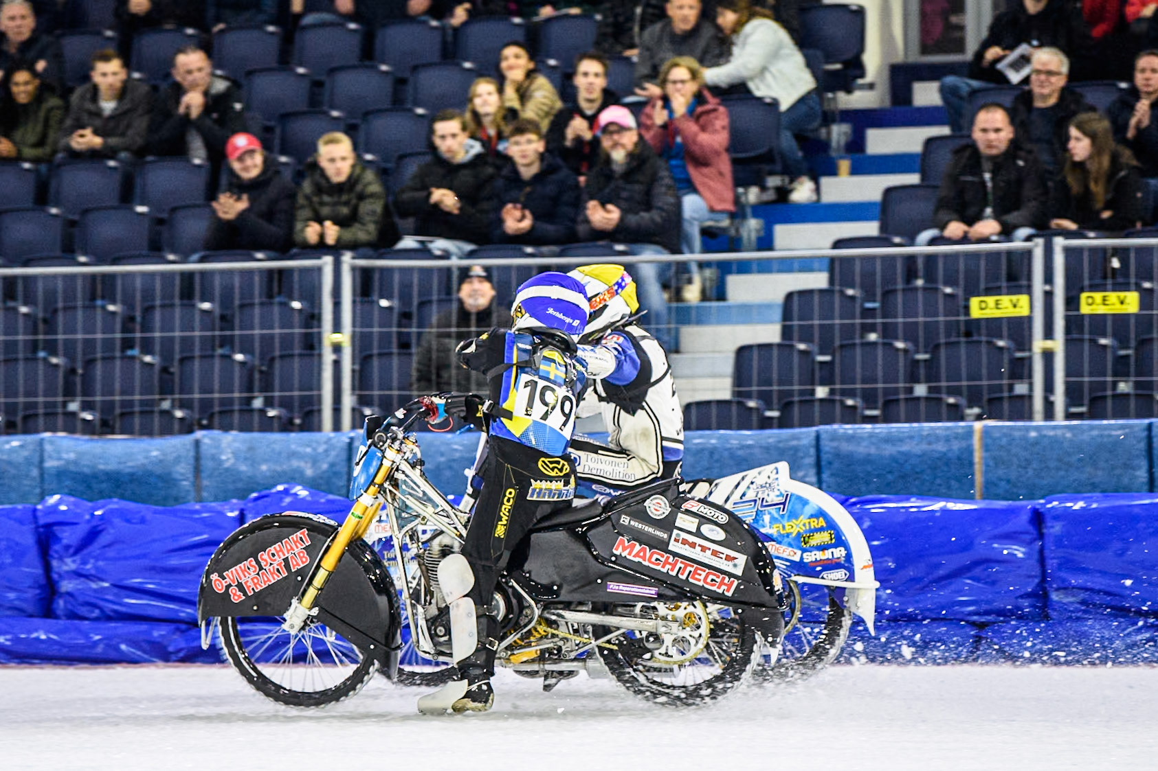 Martin Haarahiltunen (199) of Sweden in Blue congratulates Max Koivula (24) of Finland in Yellow after his win in heat 8 during the FIM Ice Speedway Gladiators World Championship, Final 4 at the Ice Stadium, Thialf, Heerenveen on Sunday 6th April 2025. (Photo: Ian Charles | MI News)