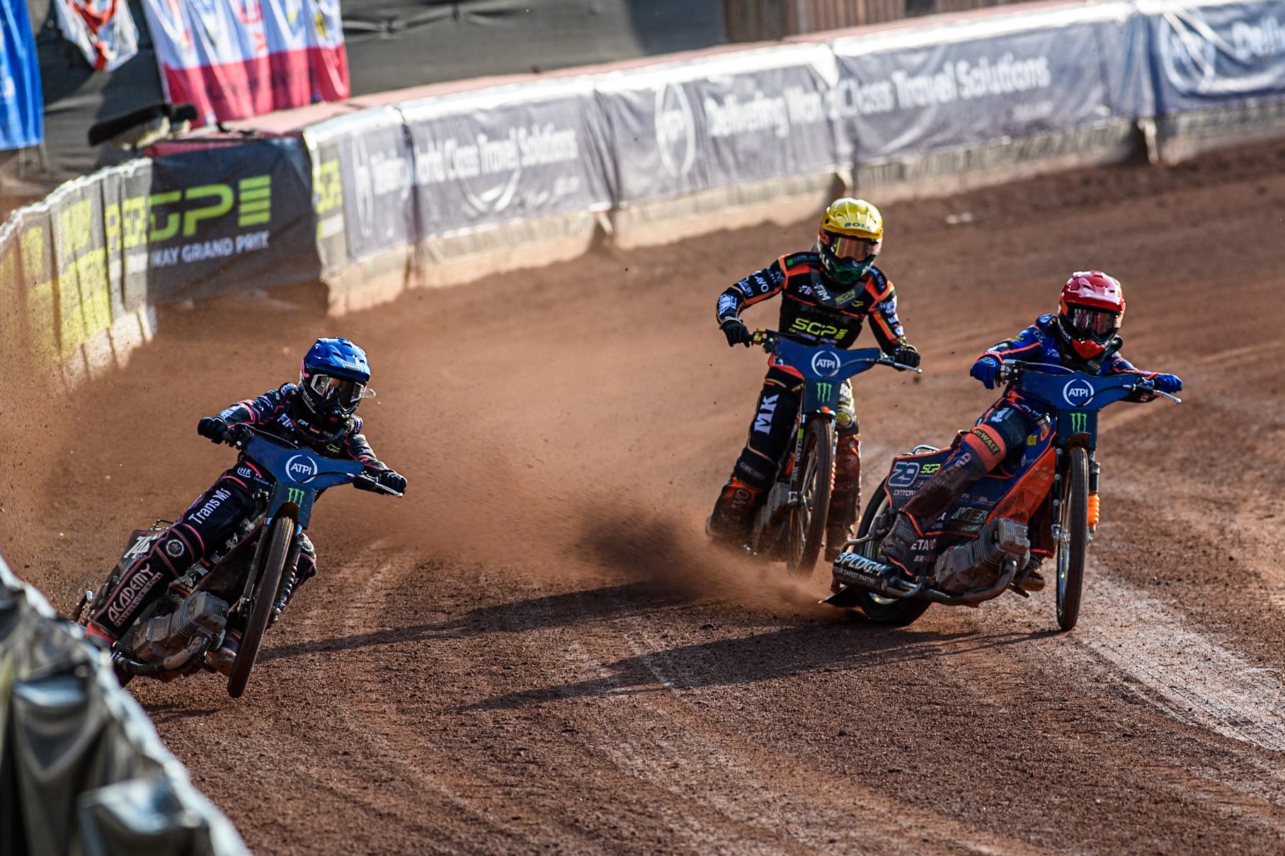Kai Huckenbeck (744) of Germany in Blue rides outside Andzejs Lebedevs (29) of Latvia in Red with Mikkel Michelsen (155) of Denmark in Yellow behind during the ATPI FIM Speedway Grand Prix Round 5 at the National Speedway Stadium, Manchester, on Saturday 14th June 2025. (Photo: Ian Charles | MI News)
