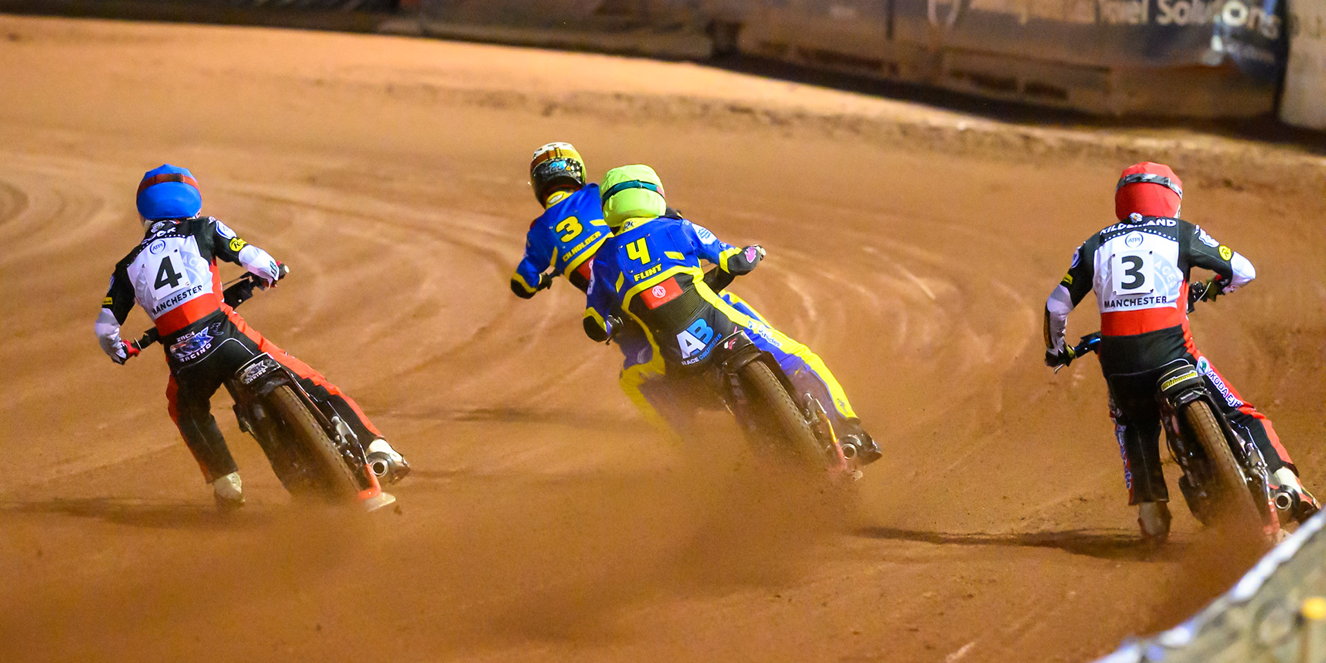 Peter Kildemand of Belle Vue Aces   in Red chases Zach Cook of Belle Vue Aces   in Blue, Leon Flint of Sheffield Tigers    in Yellow and Chris Holder of Sheffield Tigers   in White during the Knockout Cup, Northern Section match between Belle Vue Aces and Sheffield Tigers at the National Speedway Stadium, Manchester on Monday 30th March 2026. (Photo: Ian Charles | MI News)