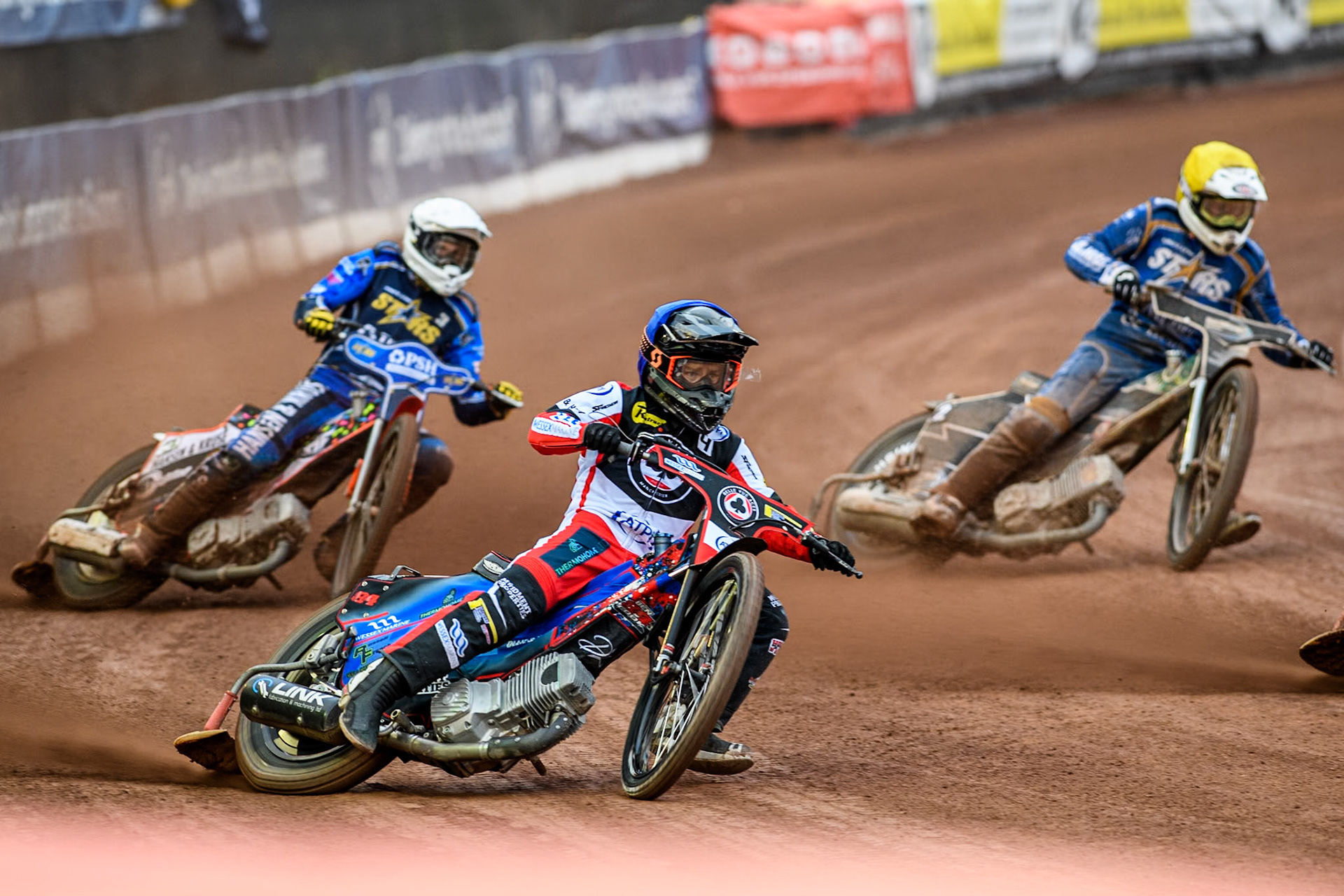 Belle Vue Aces' Ben Cook in Blue leading King Lynn Stars' Niels-Kristian Iversen in White and King Lynn Stars' Guest Richard Lawson in Yellow during the Rowe Motor Oil Premiership match between Belle Vue Aces and King's Lynn Stars at the National Speedway Stadium, Manchester on Monday 20th May 2024. (Photo: Ian Charles | MI News)