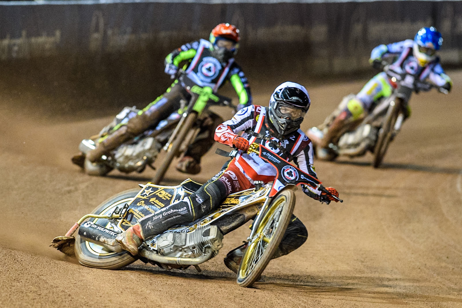 Germany's Norick Blödorn (White) leads  Australia's Jason Doyle (Red) and Poland’s Maceij Janowski (Blue) during the Peter Craven Memorial Trophy meeting at the National Speedway Stadium, Manchester on Monday 18th March 2024. (Photo: Ian Charles | MI News)