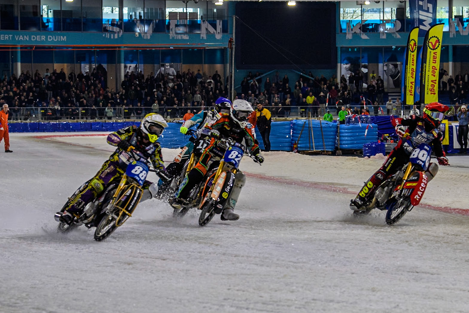 Netherlands' Jasper Iwema (800) in Red rides inside Germany's Markus Jell (82) in White and Germany's Max Niedermaier (88) in Yellow with Reserve  Sweden's Filip Jäger (17) in Blue behind during the FIM Ice Speedway Gladiators World Championship Final 4 at Ice Rink Thialf, Heerenveen on Sunday 7th April 2024. (Photo: Ian Charles | MI News)