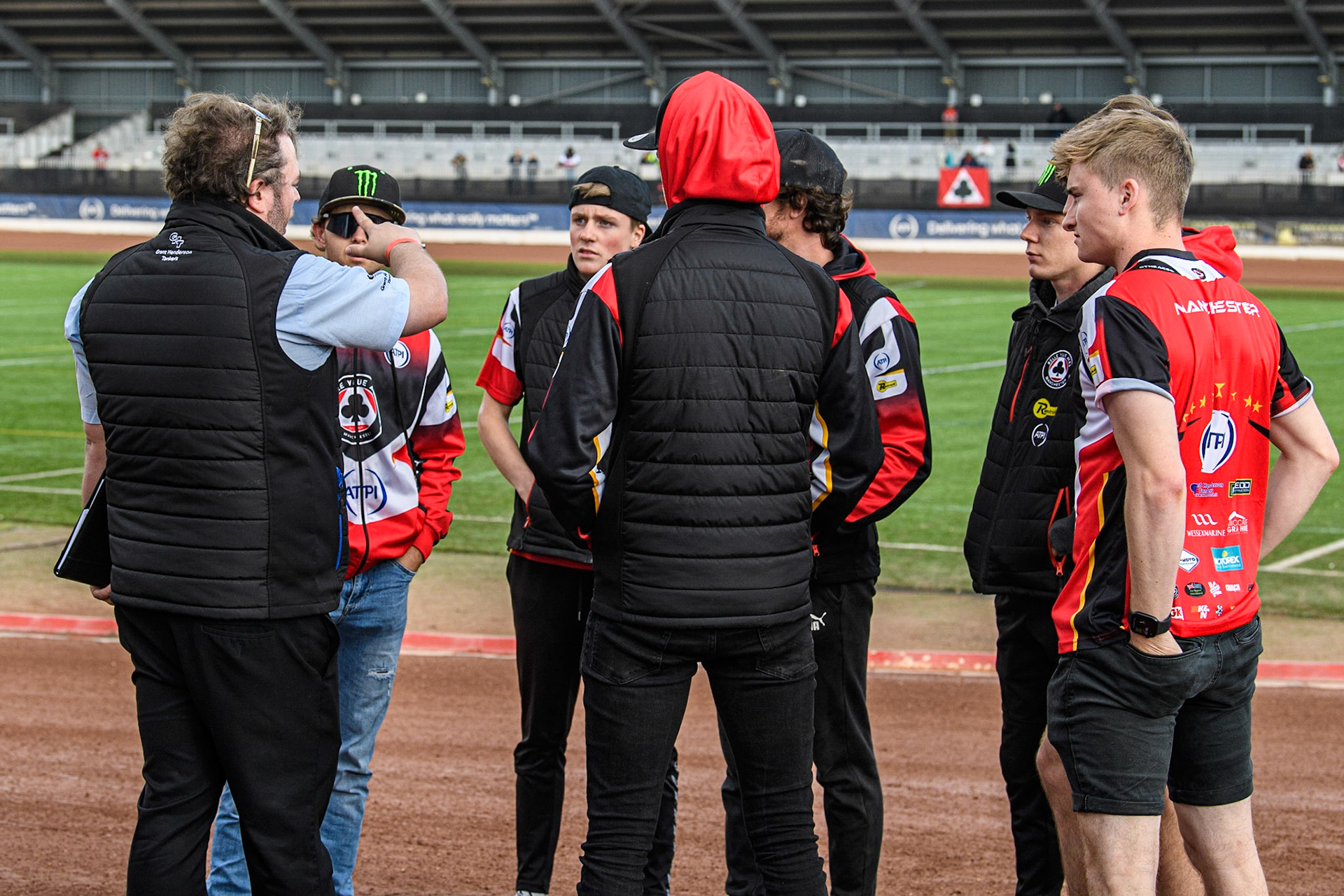 Referee Seth Perkins (left, blue shirt) has an on track meeting with the Belle Vue ATPI Aces during the Sports Insure Premiership match between Belle Vue Aces and Ipswich Witches at the National Speedway Stadium, Manchester on Monday 17th July 2023. (Photo: Ian Charles | MI News)