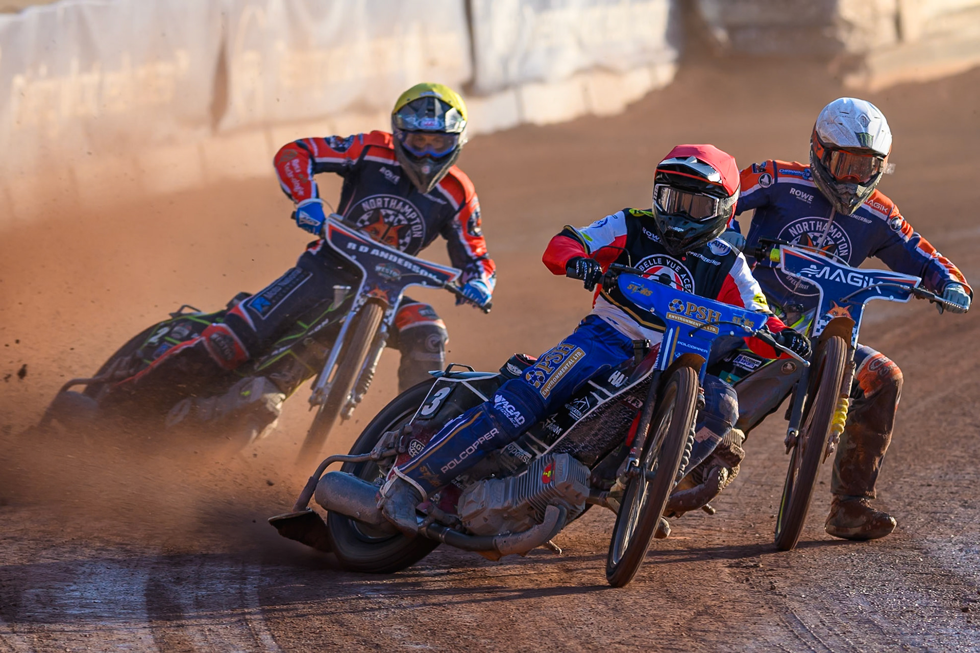 Ben Cook, Guest Rider for Belle Vue Aces in Red leading Jaimon Lidsey of Northampton Foxes  in White and Kye Thomson of Northampton Foxes in Yellow during the Rowe Motor Oil Premiership match between Belle Vue Aces and Northampton Foxes at the National Speedway Stadium, Manchester on Monday 13th July 2026. (Photo: Ian Charles | MI News)