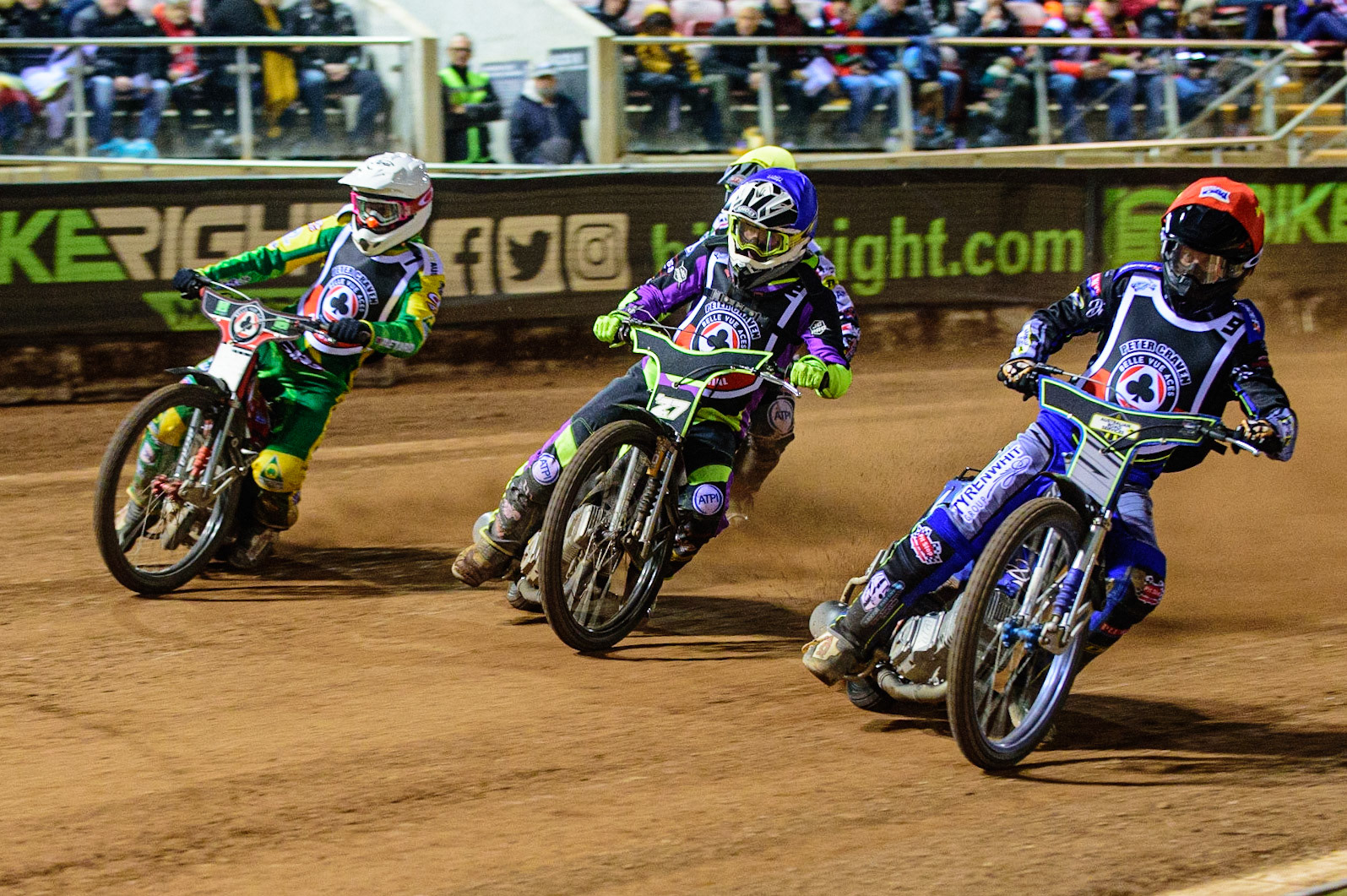MANCHESTER, UK. OCT 23RD  Ryan Douglas  (Red) inside Tom Brennan  (Blue) and Max Fricke  (Yellow) with Charles Wright  (Yellow) behind during the Peter Craven Memorial Trophy event at the National Speedway Stadium, Manchester on Saturday 23rd October 2021. (Credit: Ian Charles | MI News)