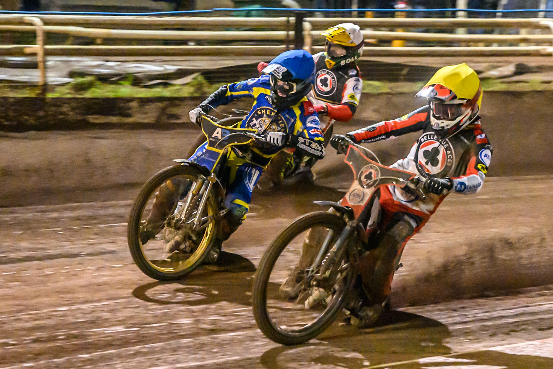 Zach Cook of Belle Vue Aces in Yellow on the inside of Anders Rowe of Sheffield Tigers in Blue  and Mitch McDiarmid, Guest rider for Belle Vue Aces in White during the Rowe Motor Oil Premiership Grand Final 1st Leg match between Sheffield Tigers and Belle Vue Aces at Owlerton Stadium, Sheffield on Monday 12th October 2026. (Photo: Ian Charles | MI News)