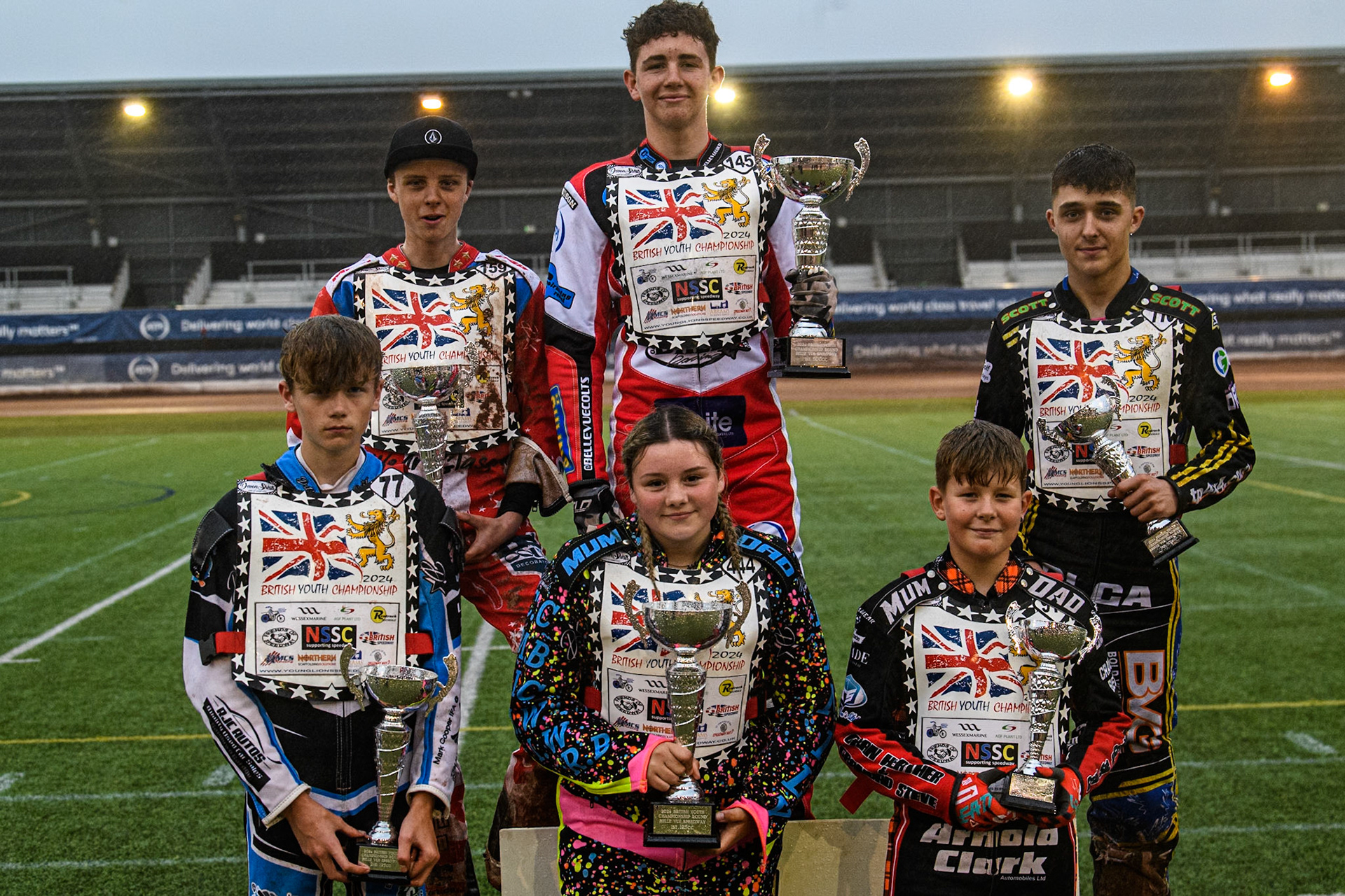 British Youth Championship: Rear (L to R) 500cc: Stene Pijper (2nd), William Cairns (Winner), William Hocaniuk (3rd). Front: (L to R) 125cc: Jack Scully-Syer (2nd), Tia May Brant  (Winner), Rhys Harrow (3rd) during the WSRA National Development League match between Belle Vue Colts and Oxford Chargers at the National Speedway Stadium, Manchester on Friday 2nd August 2024. (Photo: Ian Charles | MI News)