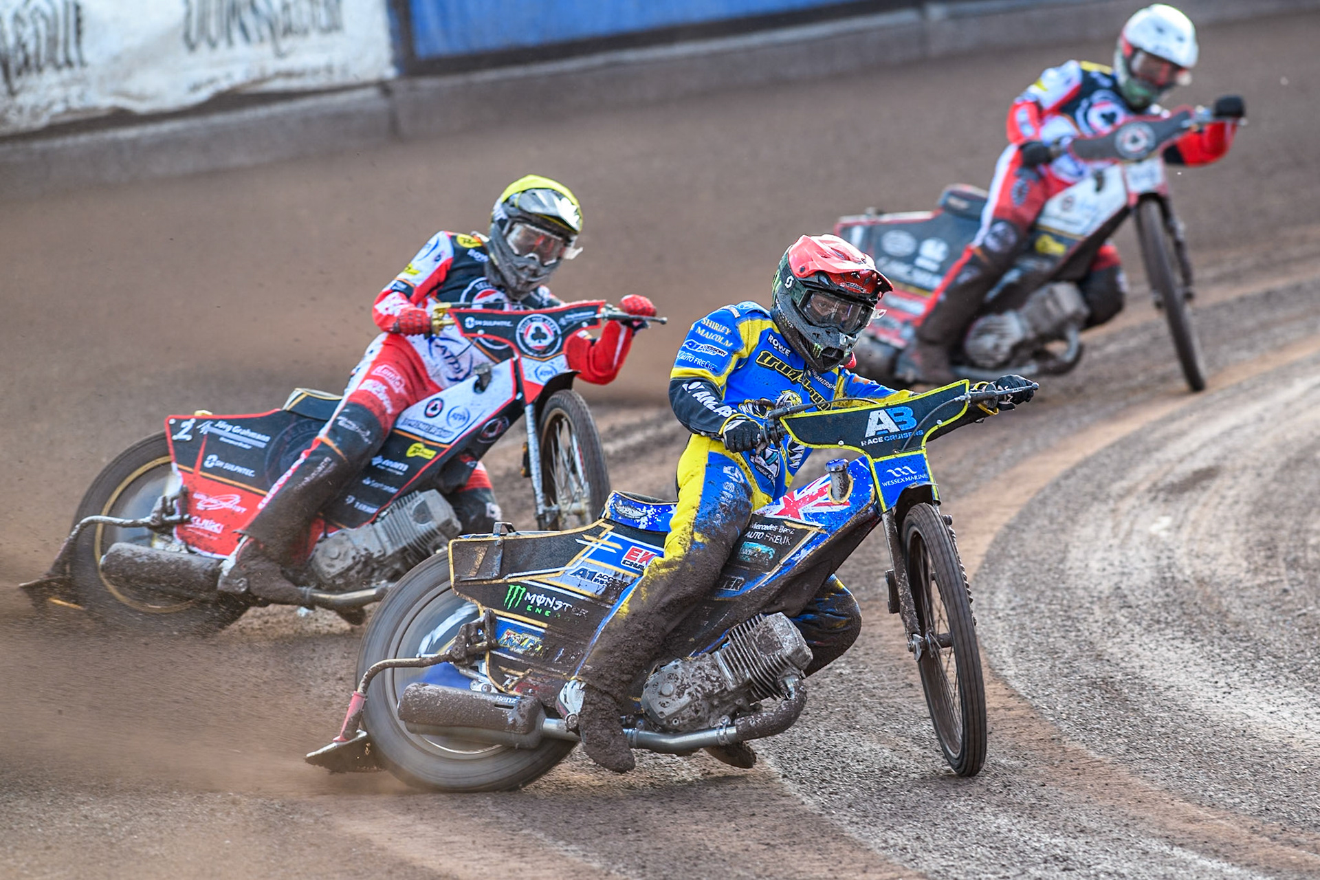 Jack Holder of Sheffield Tigers in Red leading Norick Blödorn of Belle Vue Aces in Yellow and Brady Kurtz of Belle Vue Aces in White during the Rowe Motor Oil Premiership match between Sheffield Tigers and Belle Vue Aces at Owlerton Stadium, Sheffield on Monday 5th May 2025. (Photo: Ian Charles | MI News)