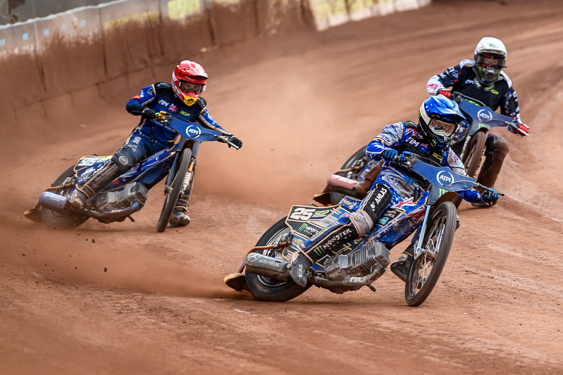 Jack Holder (25) of Australia in Blue leading Robert Lambert (505) of Great Britain in Red and Fredrik Lindgren (66) of Sweden in White during the ATPI FIM Speedway Grand Prix Round 4 at the National Speedway Stadium, Manchester, on Friday 13th June 2025. (Photo: Ian Charles | MI News)